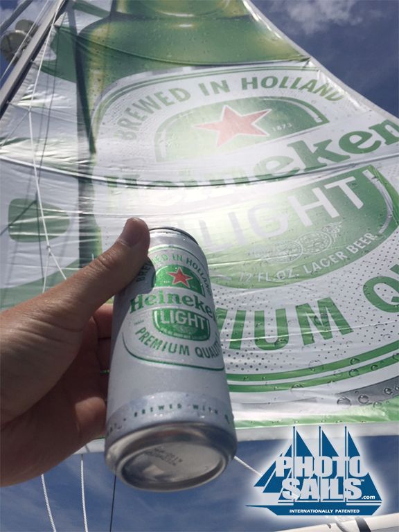 A person holding a can of heineken light beer