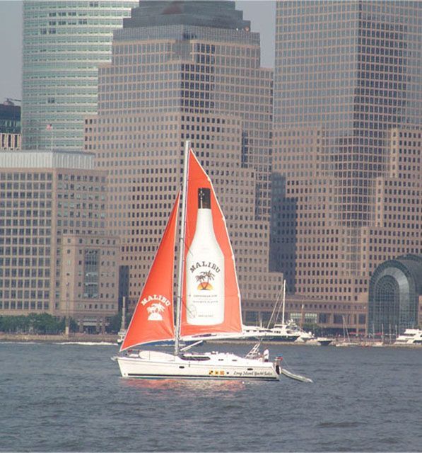 A sailboat with a bottle of malibu on the sail