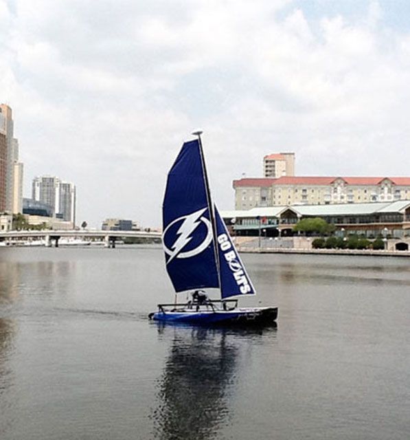 A sailboat with a lightning bolt on the sail