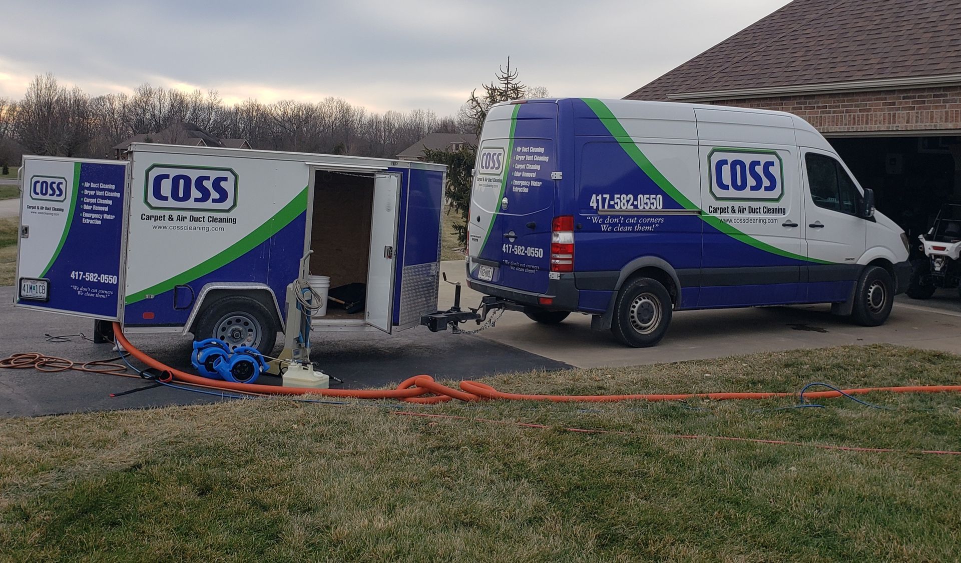 Two coss vans are parked next to each other