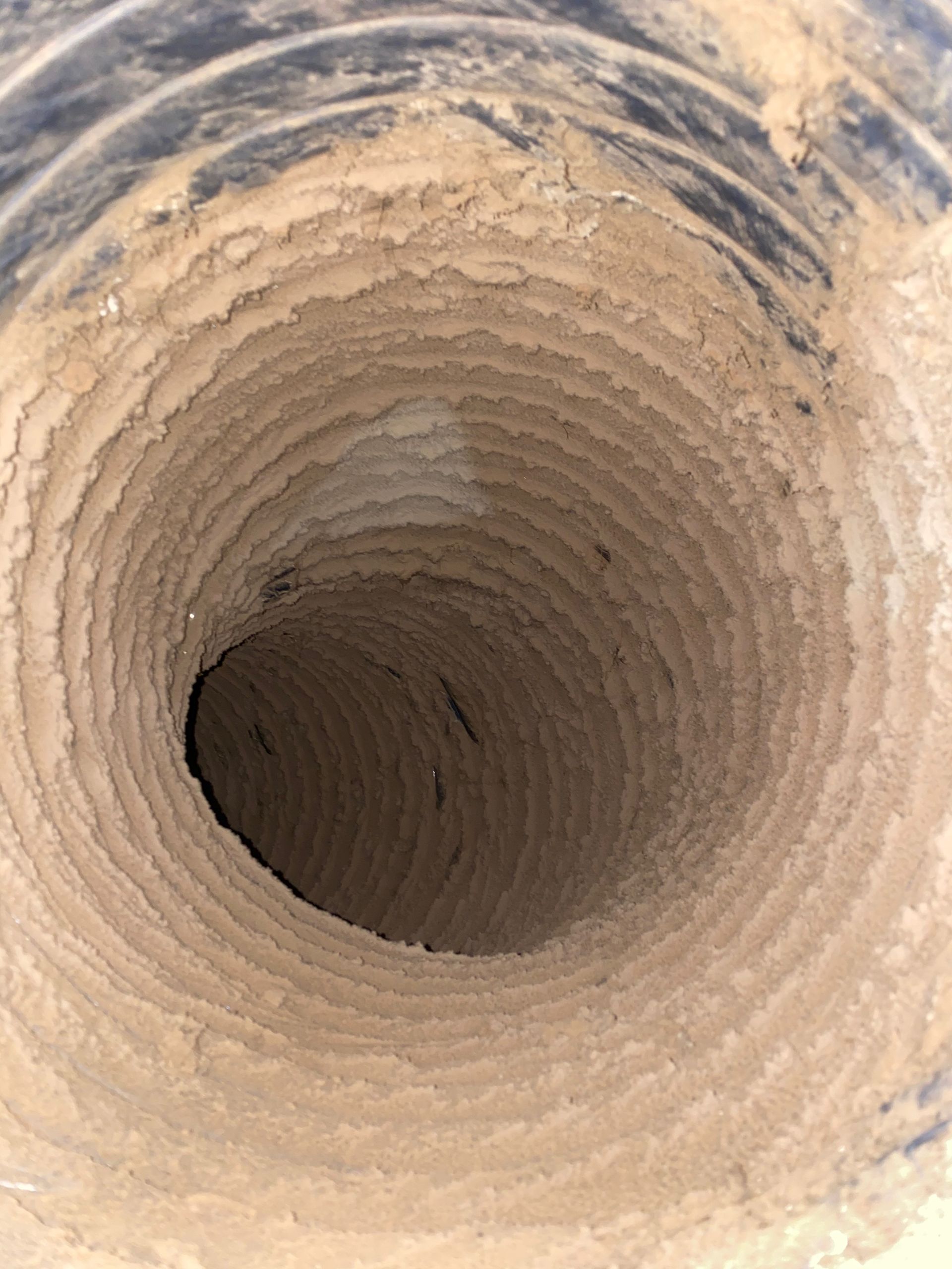 A hole in the ground that looks like a vortex