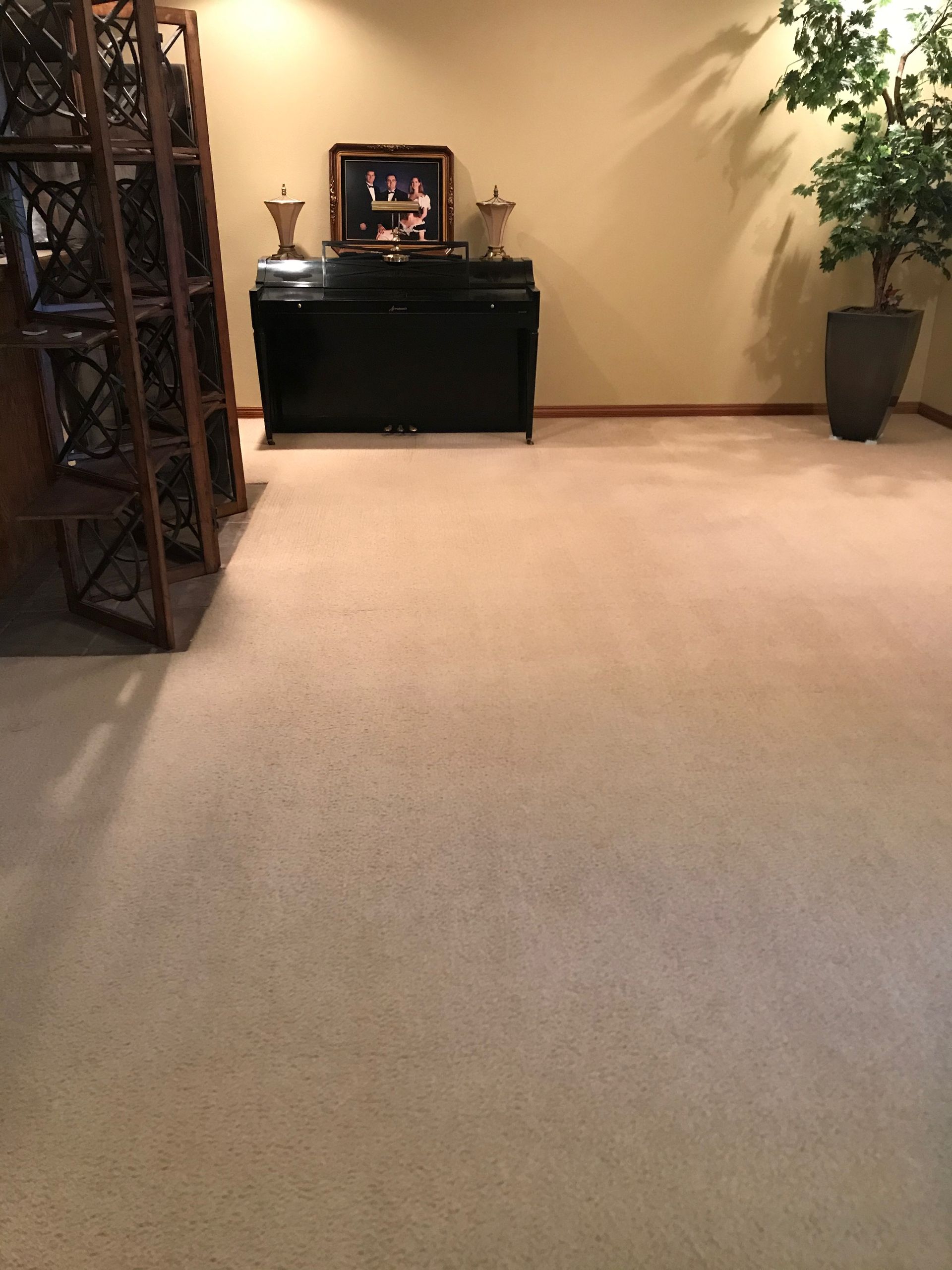 A room with a piano and a picture on the wall