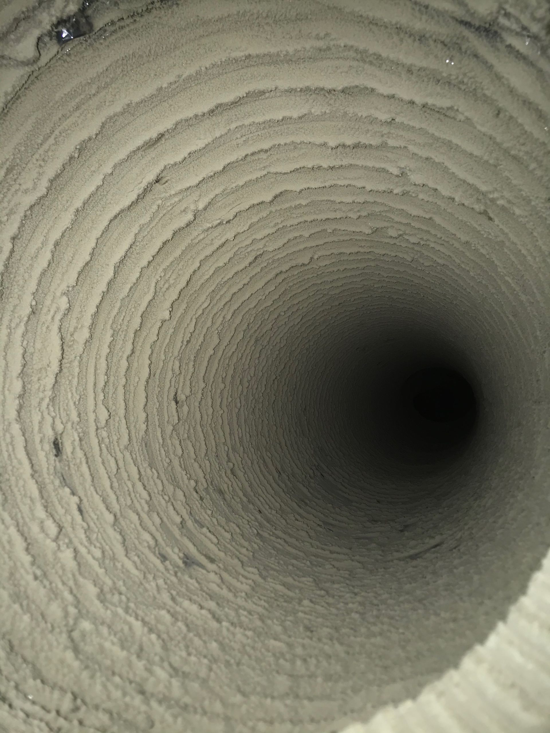 A close up of the inside of a dirty air duct.