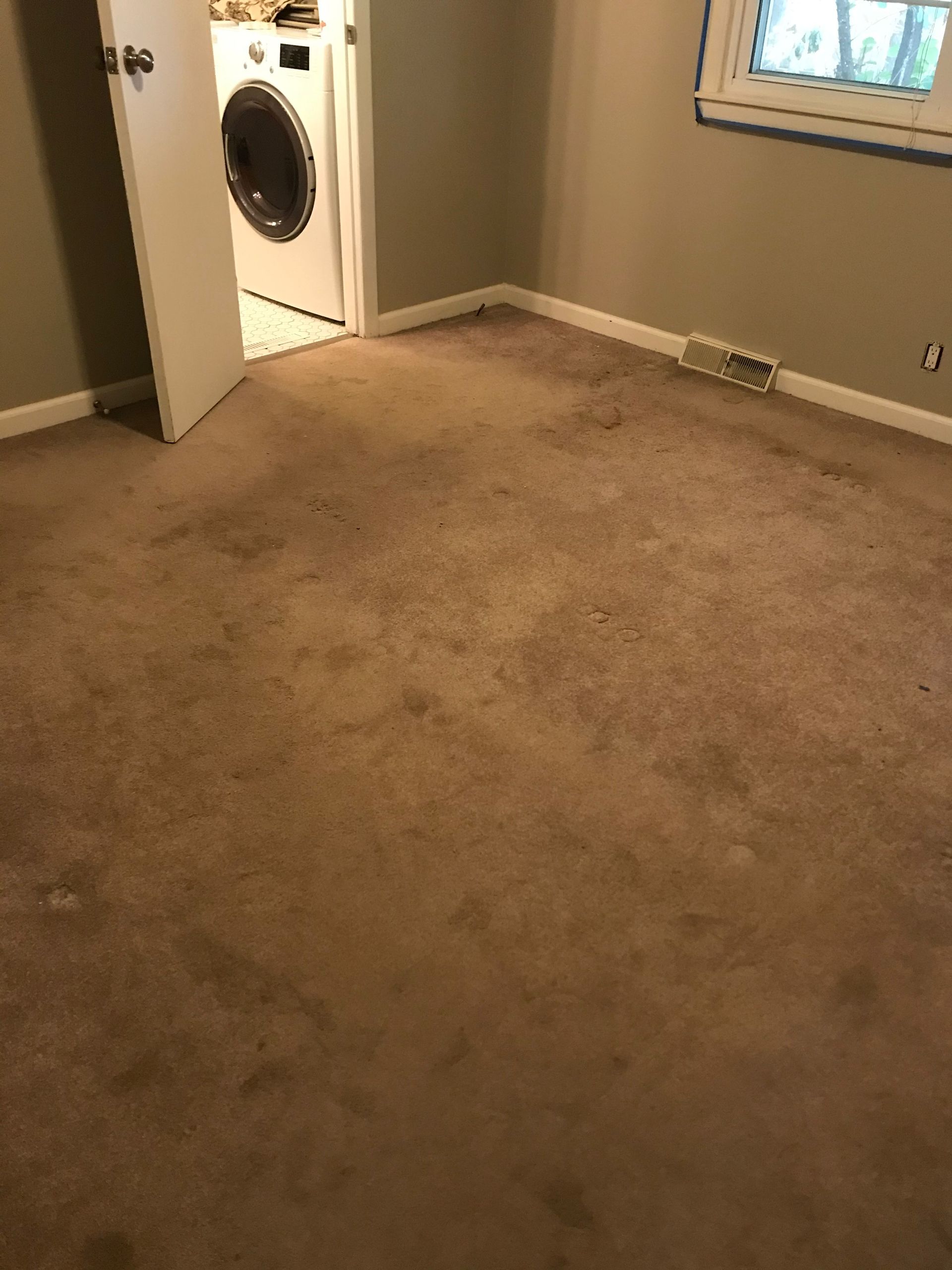 A room with a washer and dryer and a window