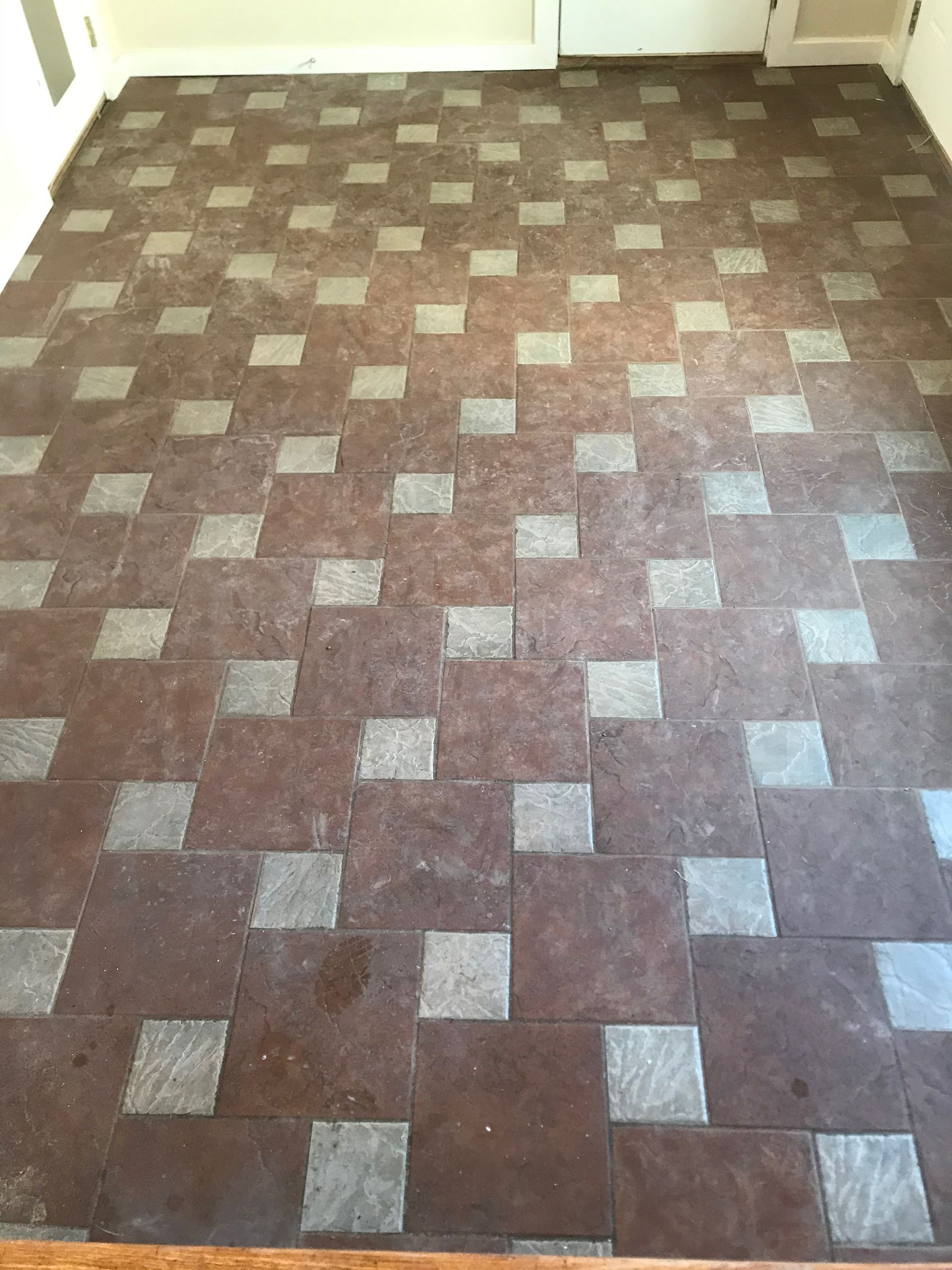 A brown and gray tile floor in a room