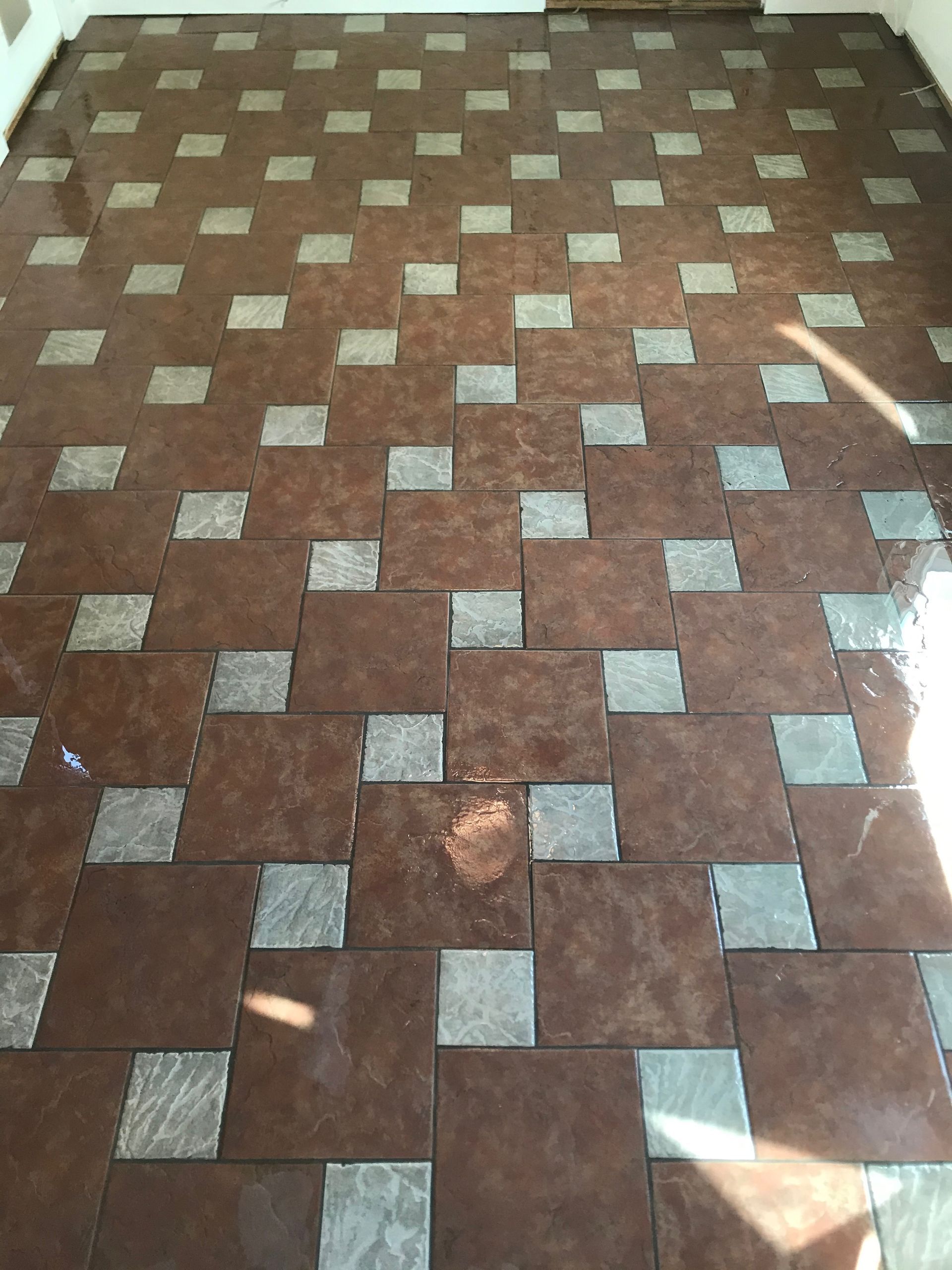 A brown tile floor with squares on it