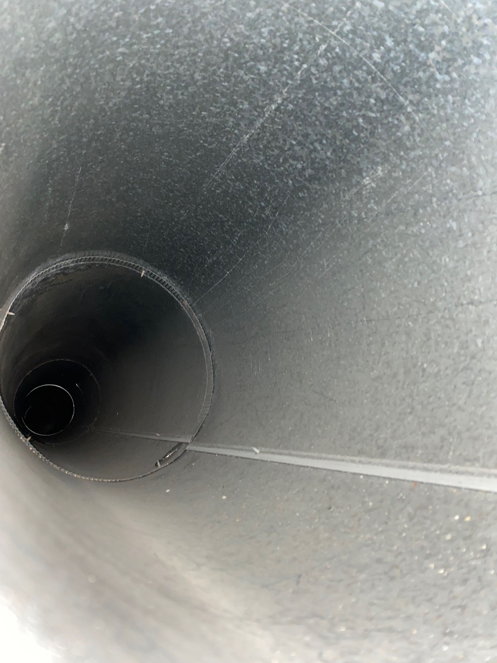 A close up of a metal pipe with a hole in the middle