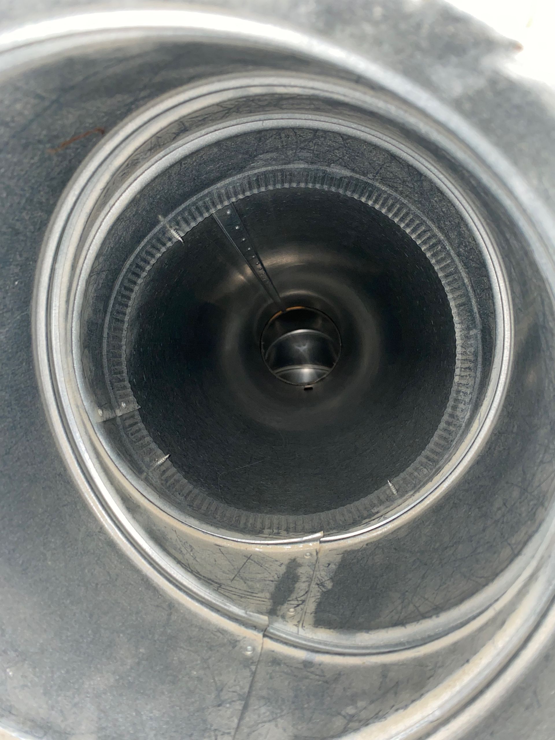 A close up of a metal pipe with a hole in the middle