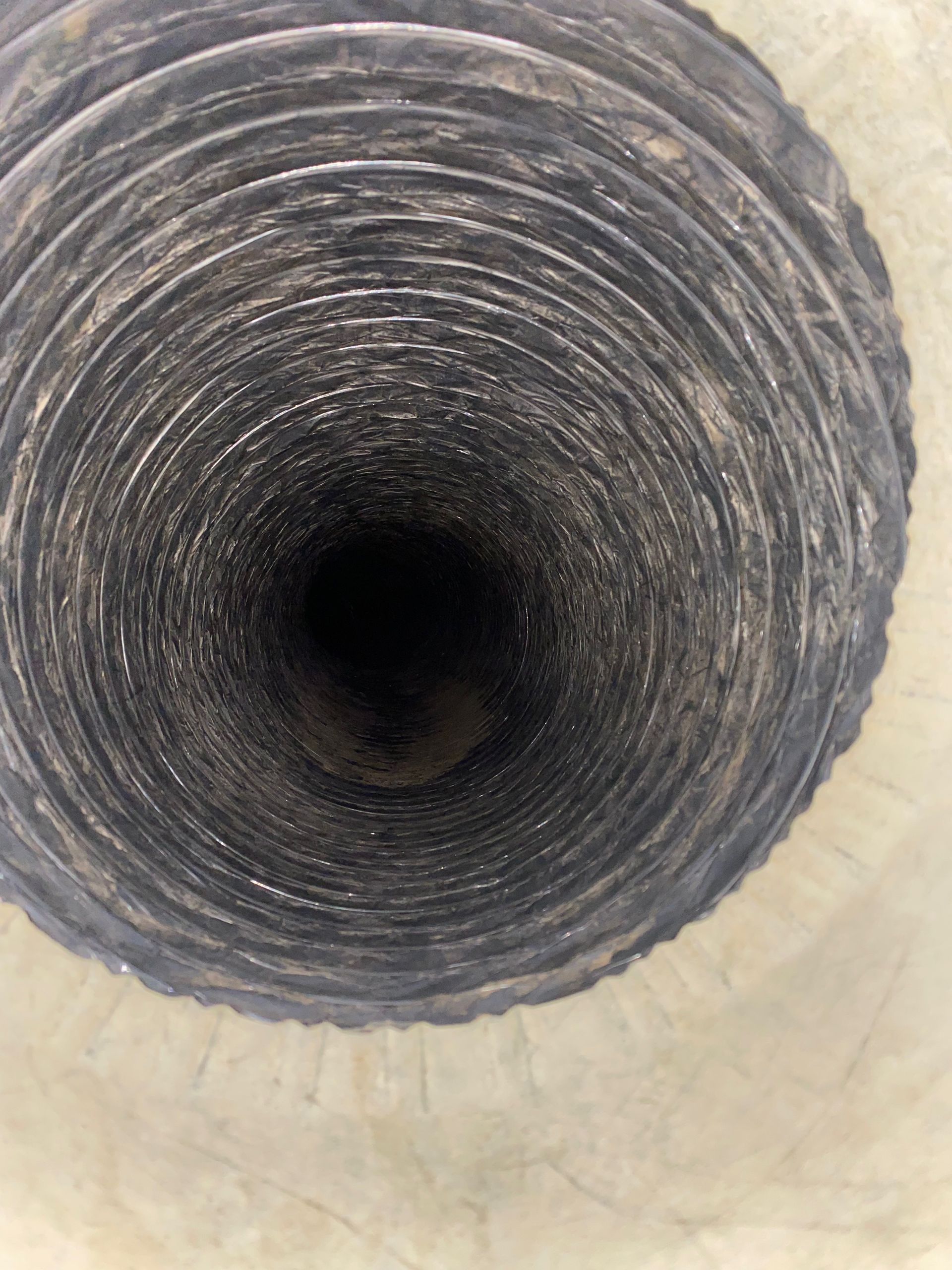 A close up of the inside of a duct with a hole in the middle.