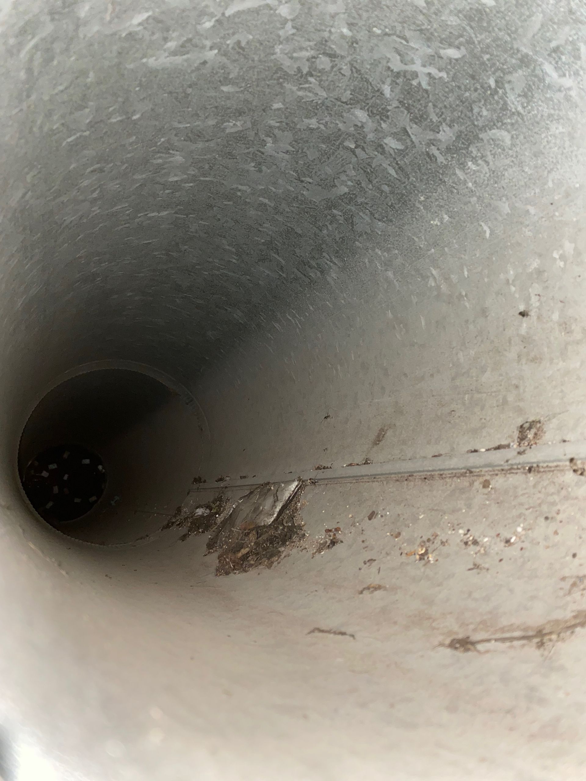 A close up of a metal pipe with a hole in the middle.