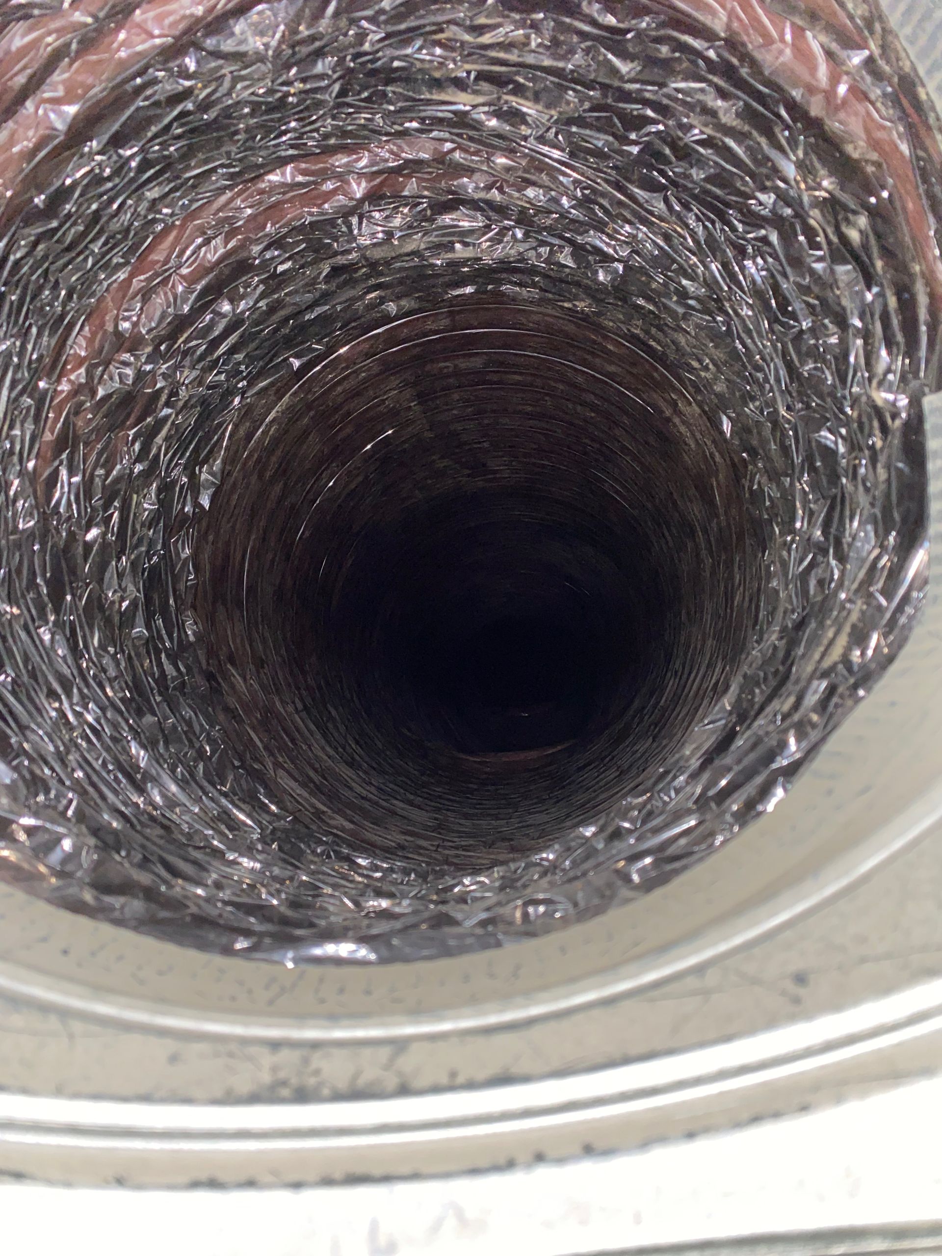 A close up of a duct with a hole in the middle