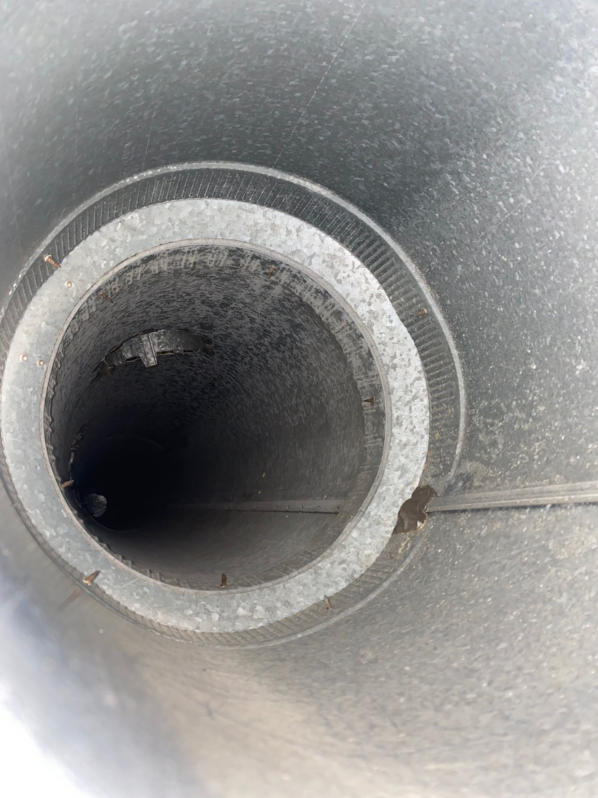 A close up of a metal pipe with a hole in the middle.