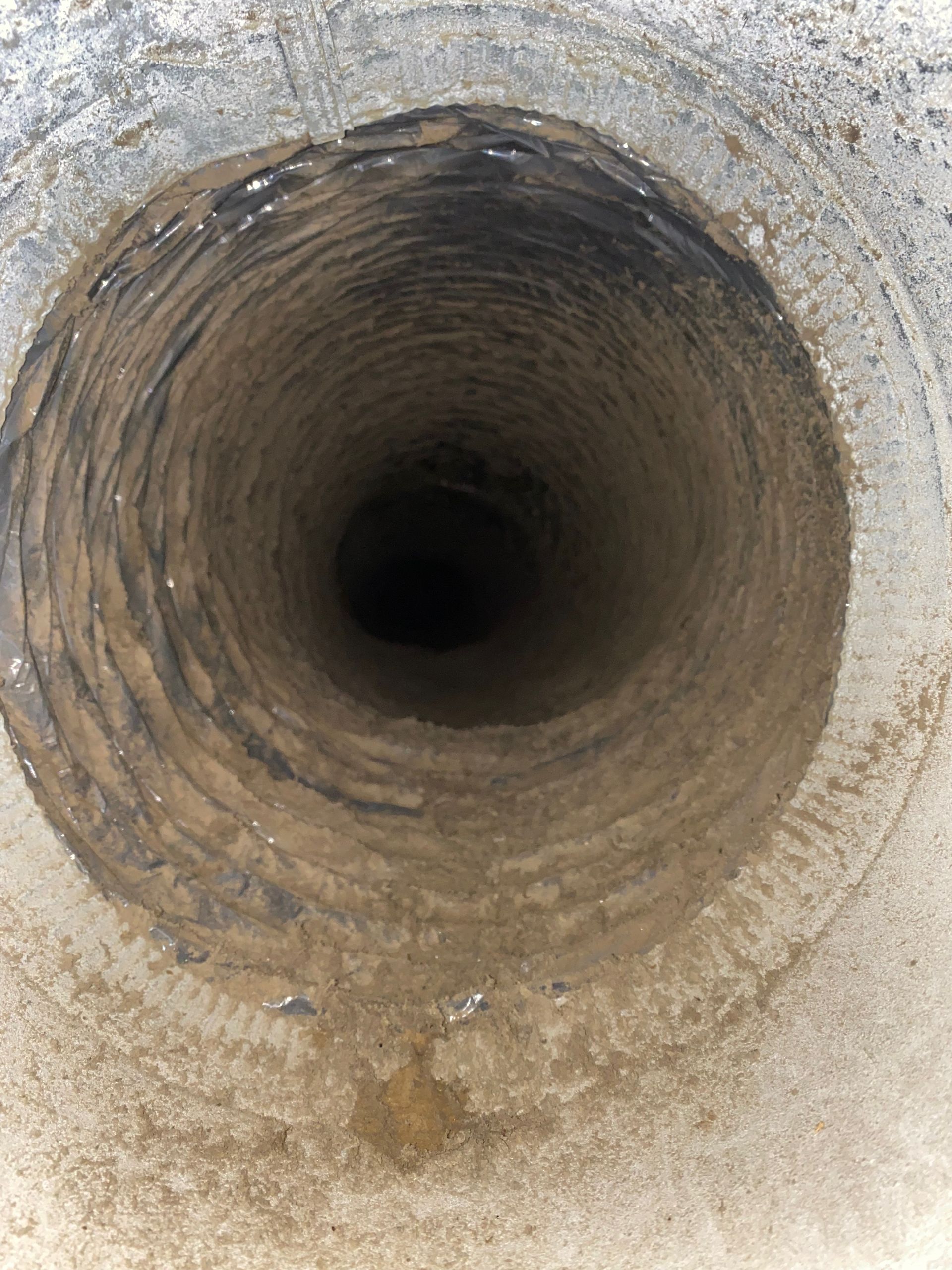A close up of a hole in a concrete wall