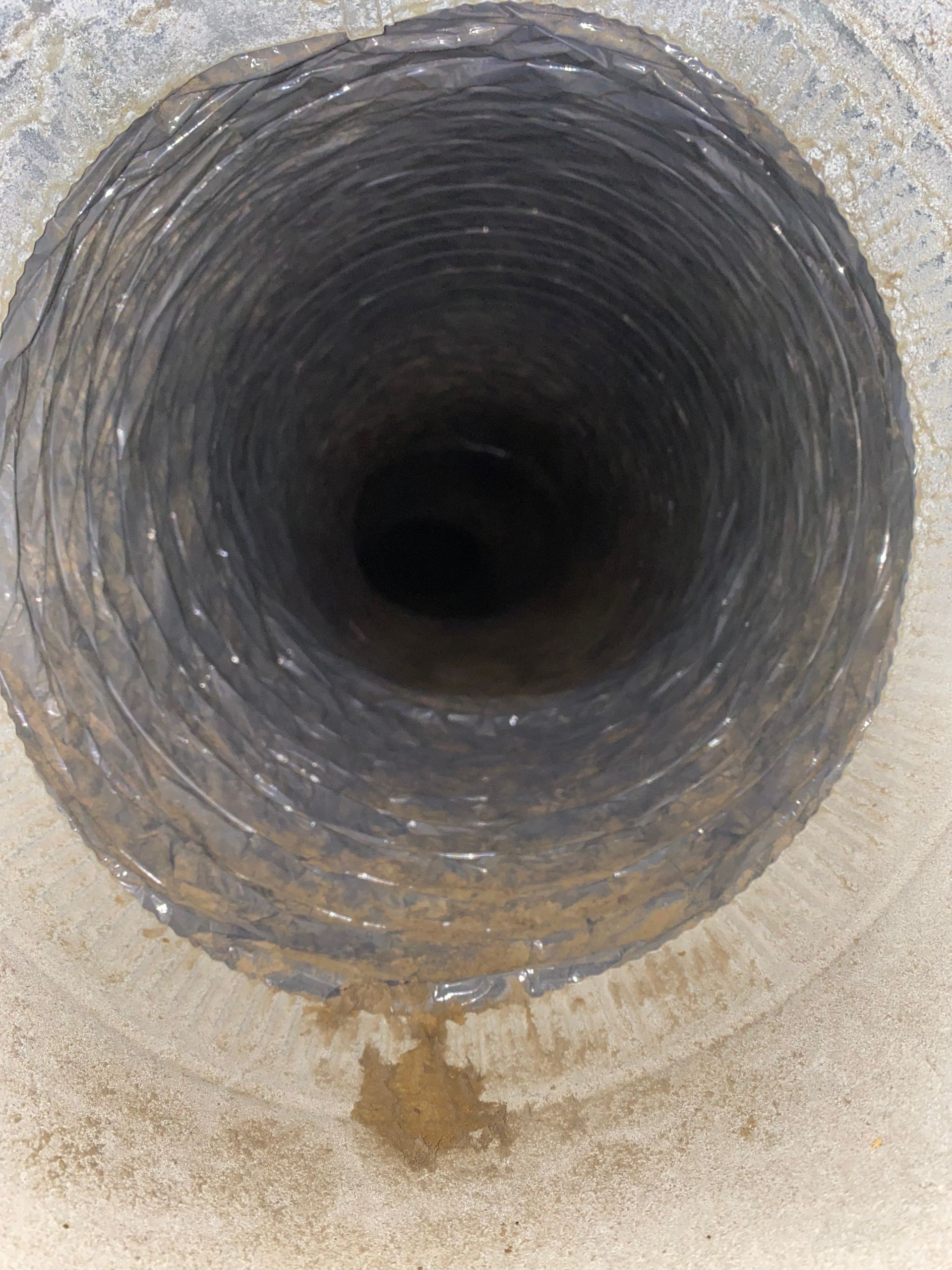 A close up of a hole in a concrete wall