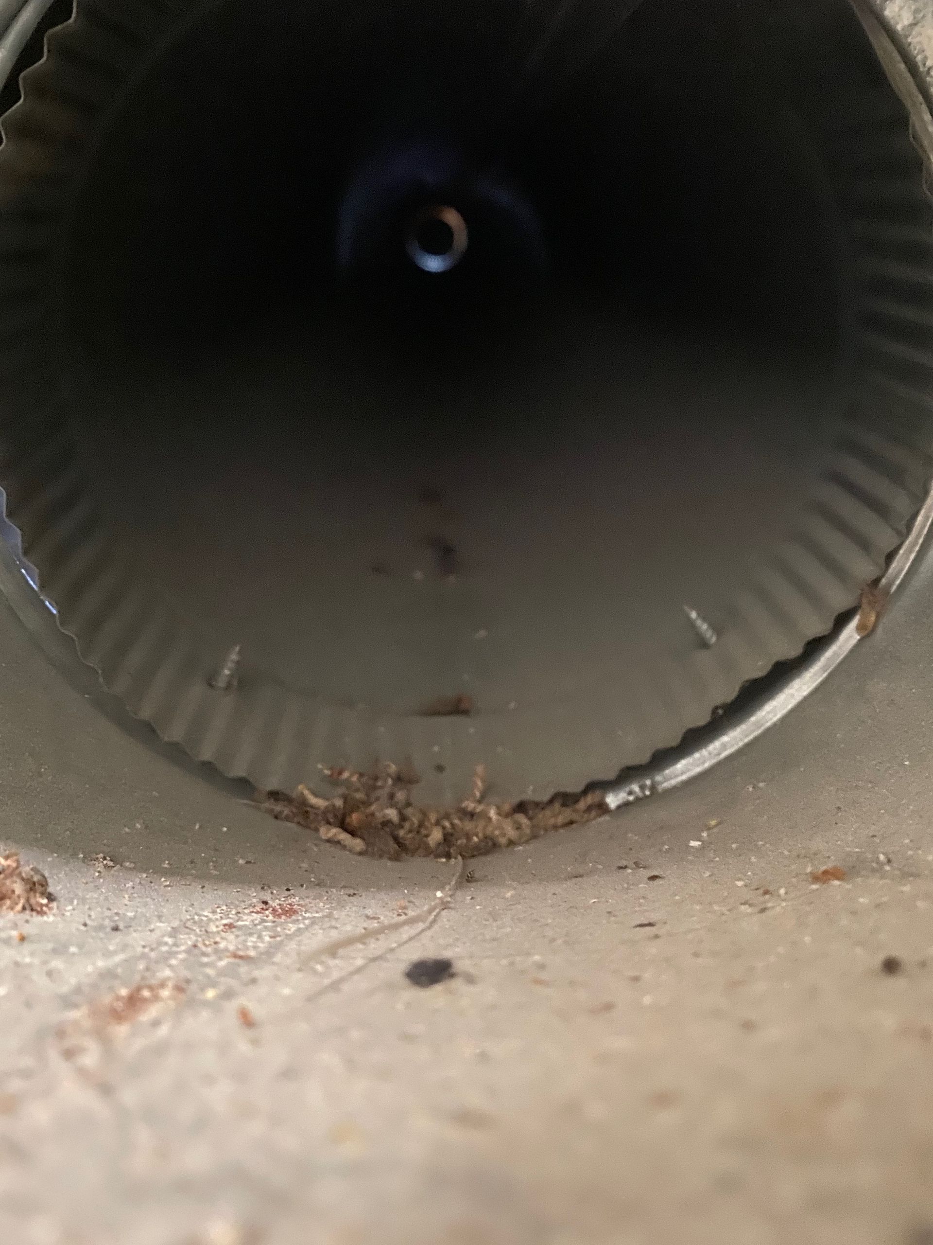 A close up of a metal pipe with a hole in the middle.