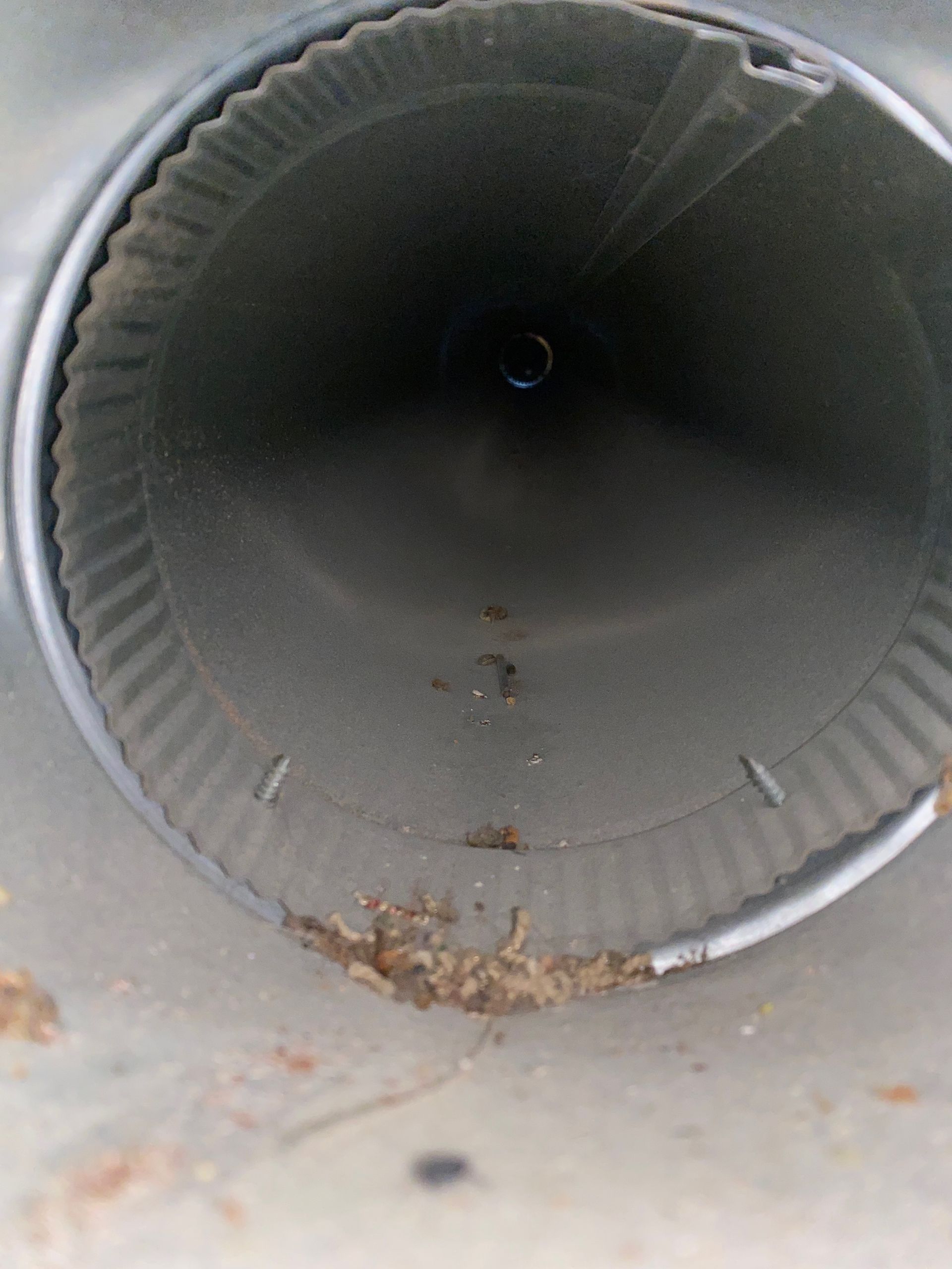 A close up of a metal pipe with a hole in the middle