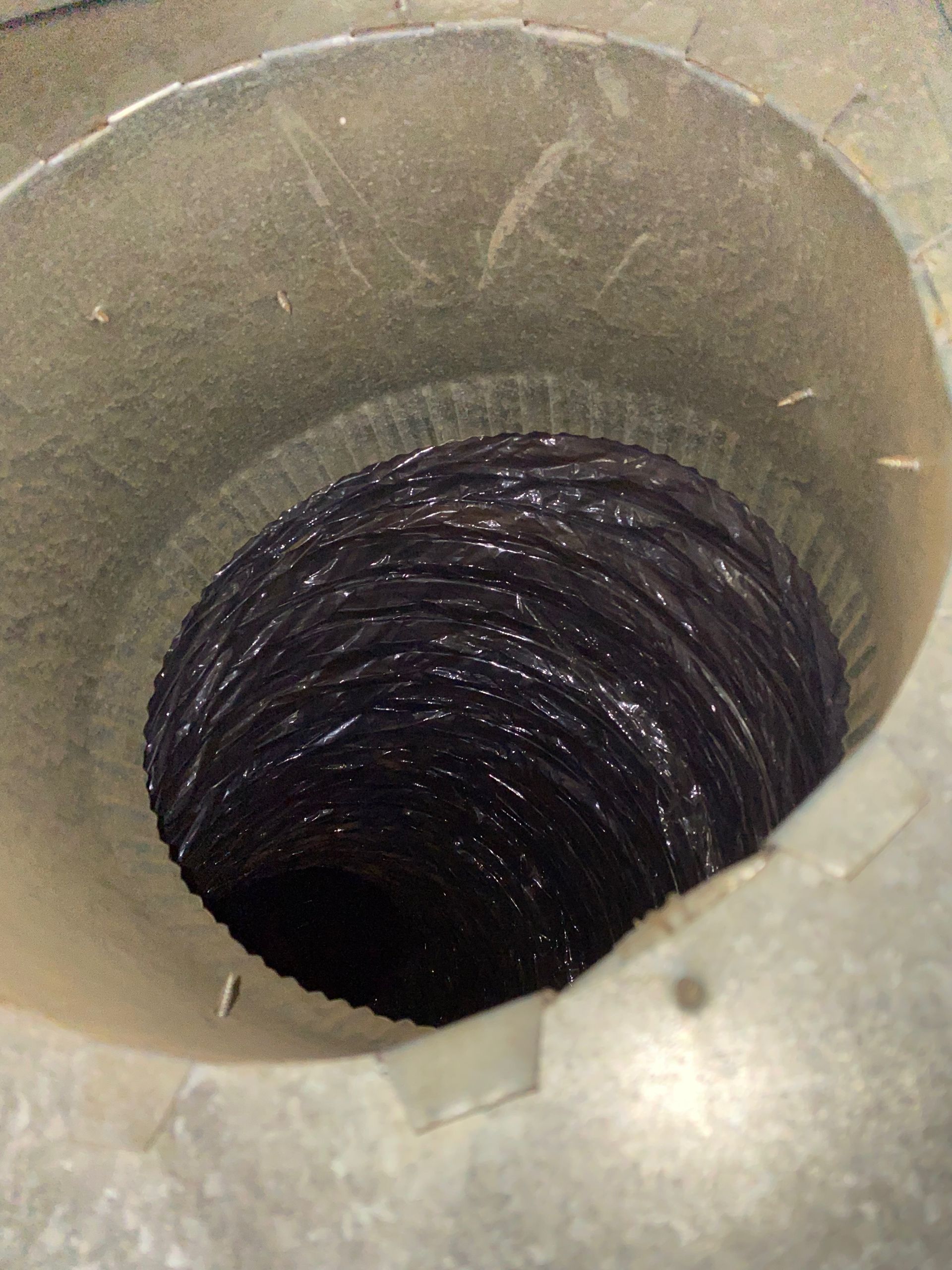 A hole in the middle of a metal pipe