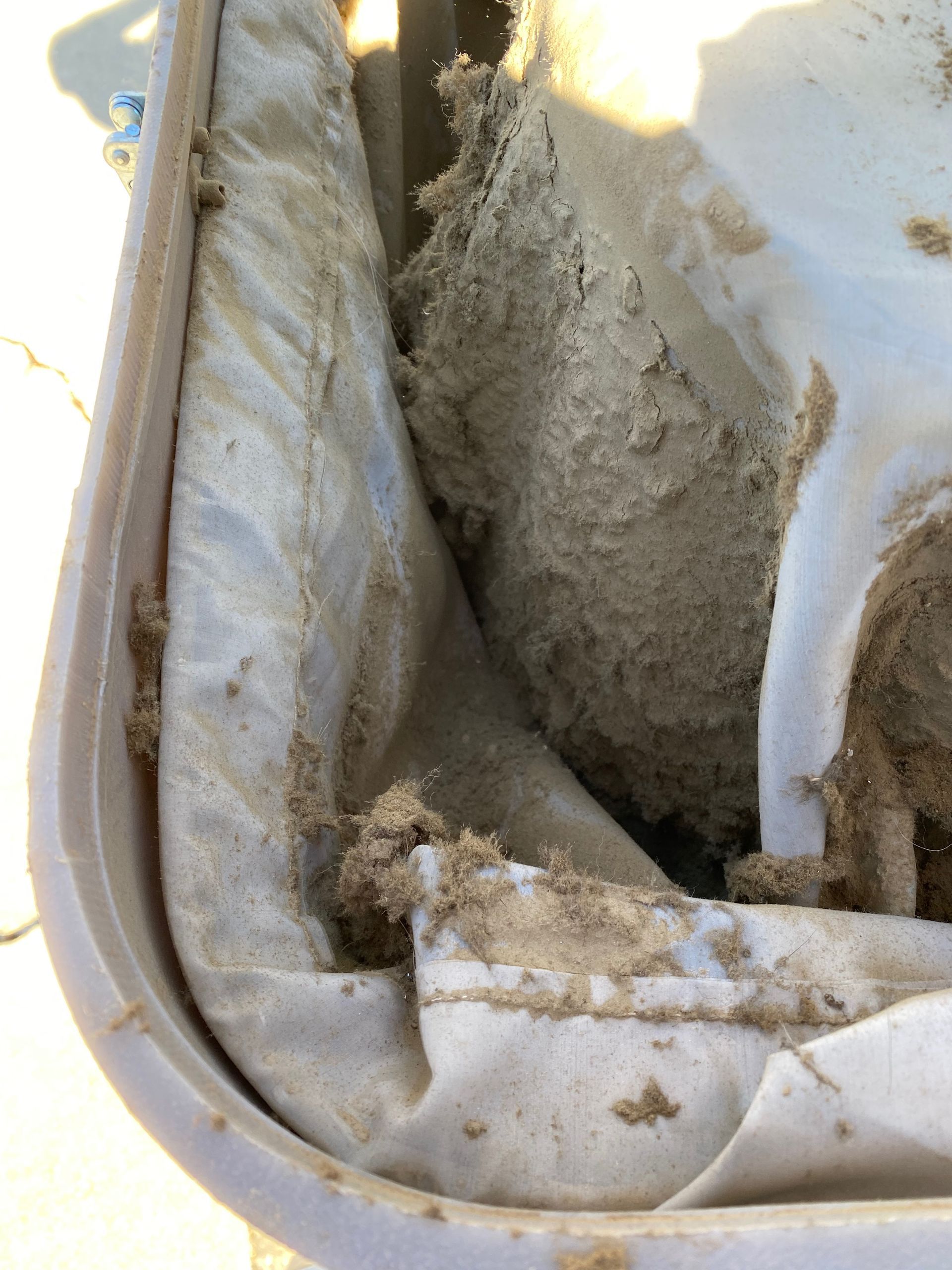 A close up of a white container filled with sand