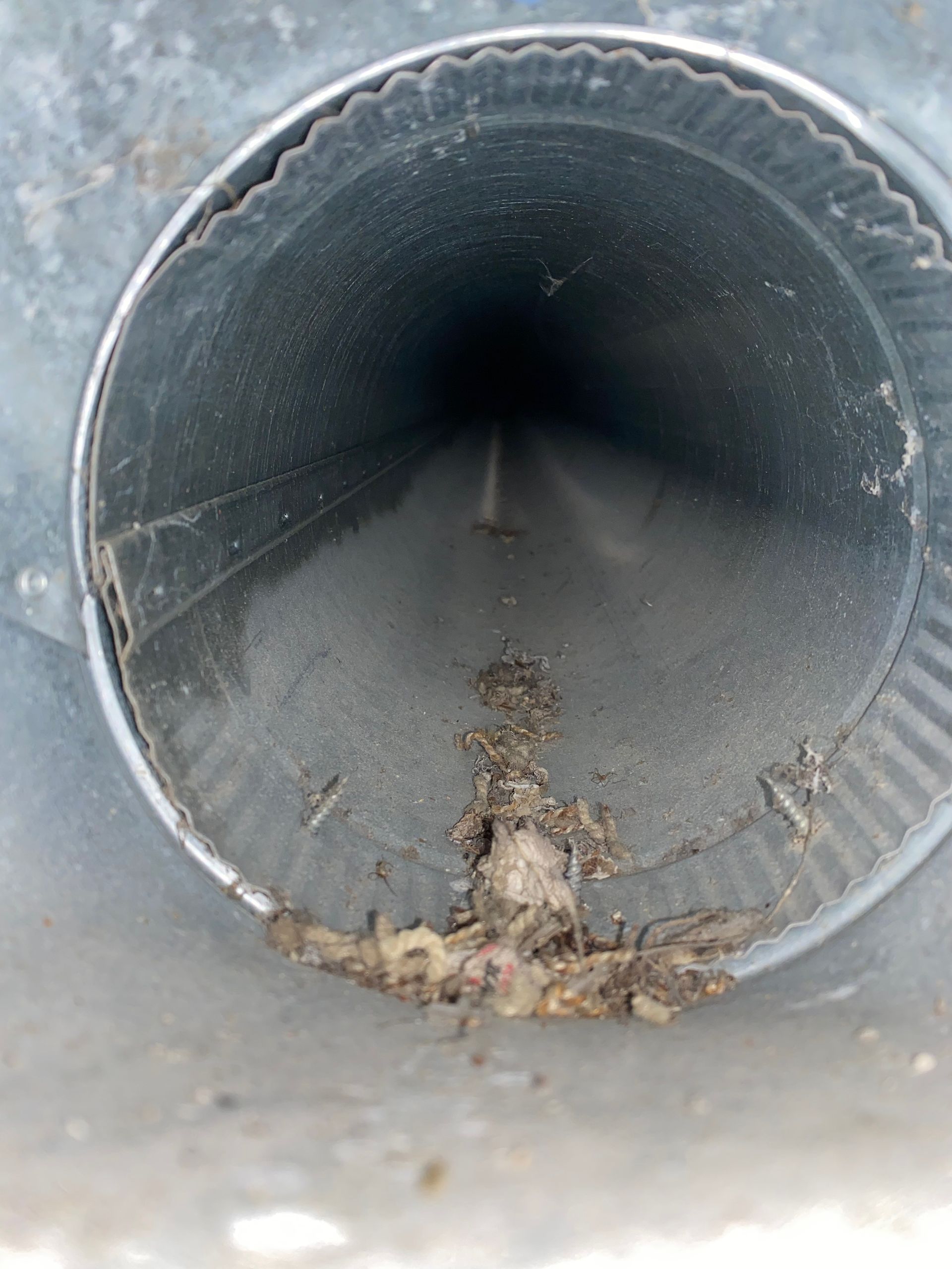 A close up of a metal pipe with a hole in the middle