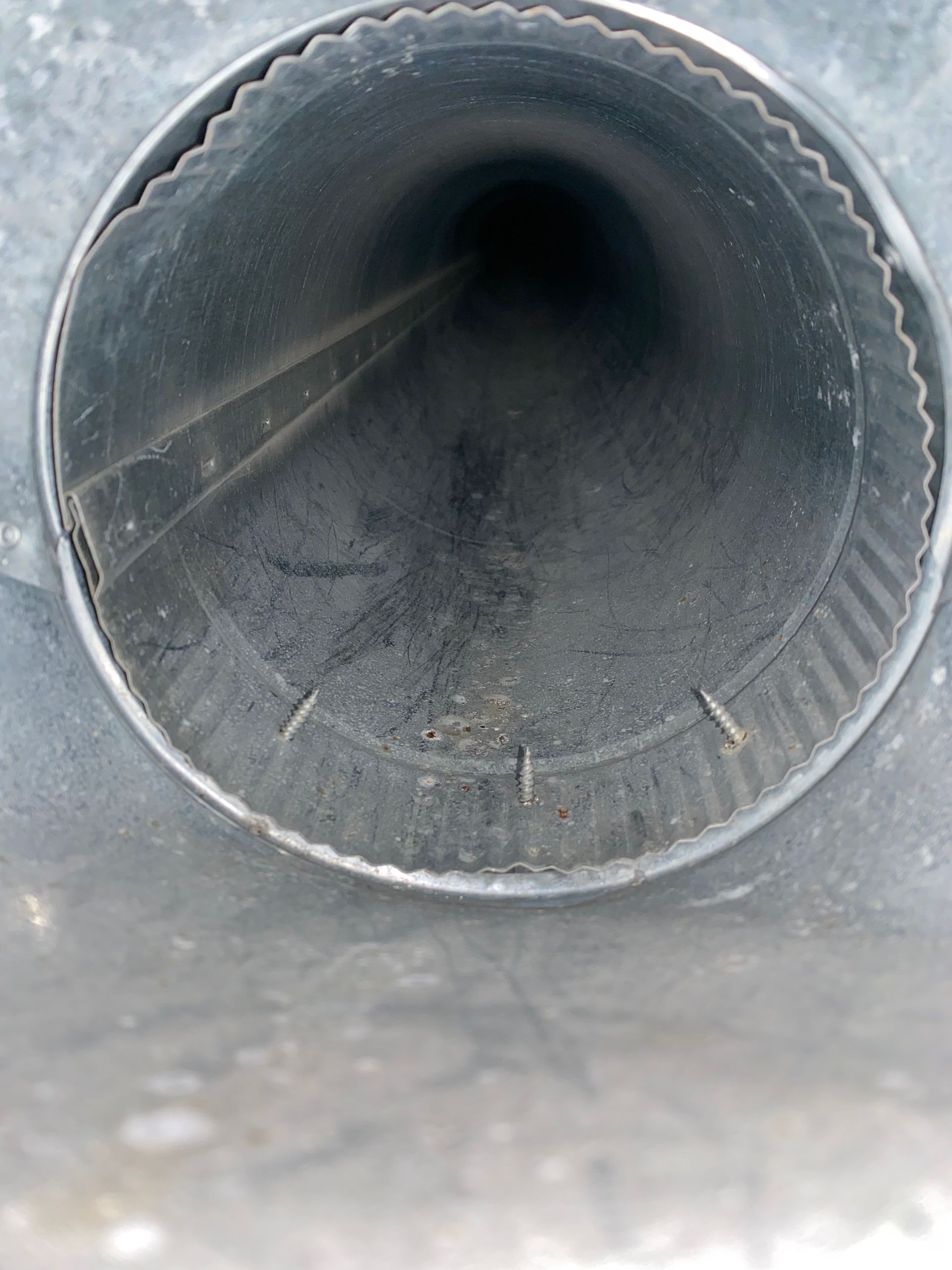 A close up of a metal pipe with a hole in the middle