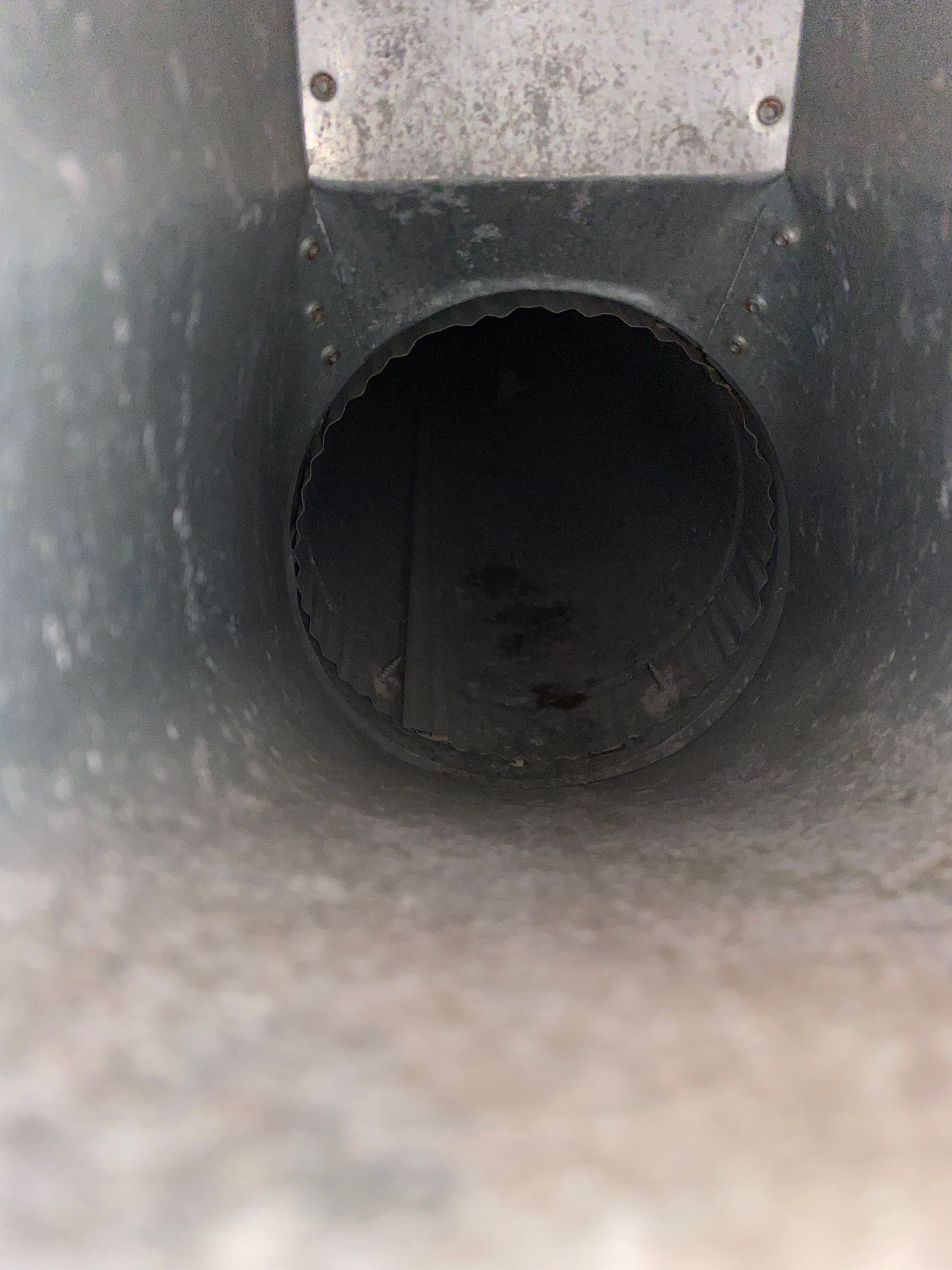 A close up of a metal pipe with a hole in the middle.