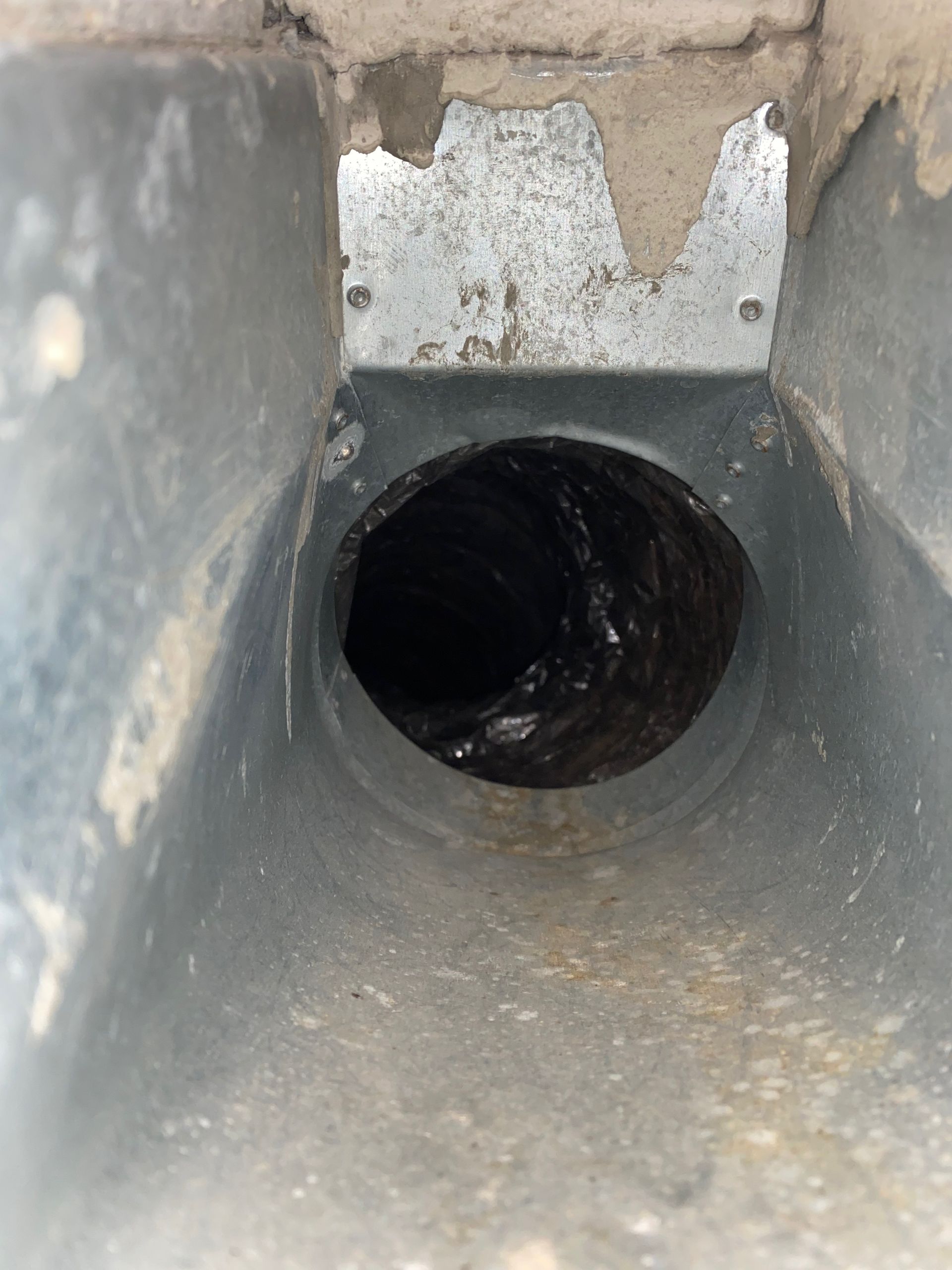 A close up of a metal pipe with a hole in the middle.