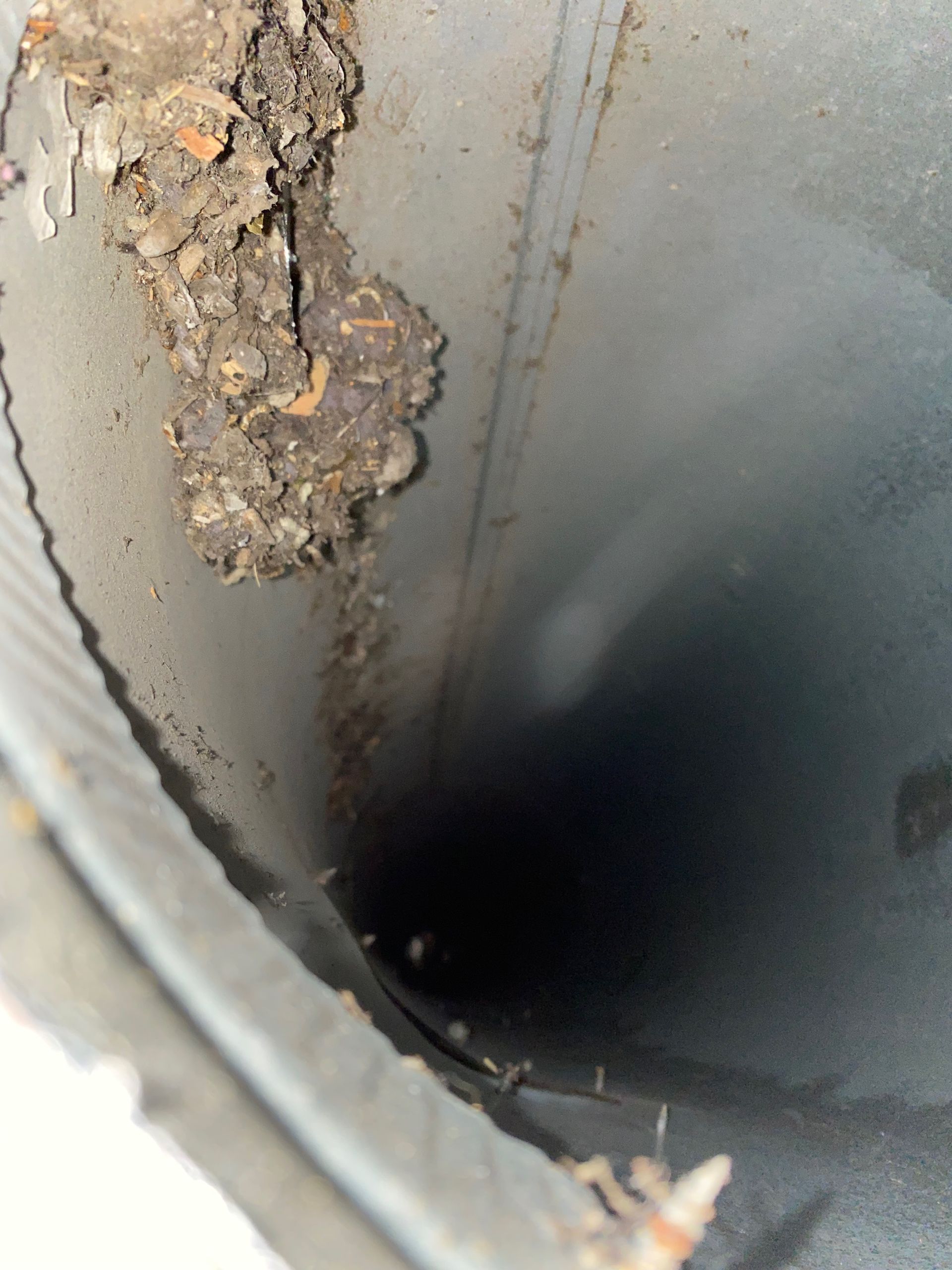 A close up of a hole in a metal pipe
