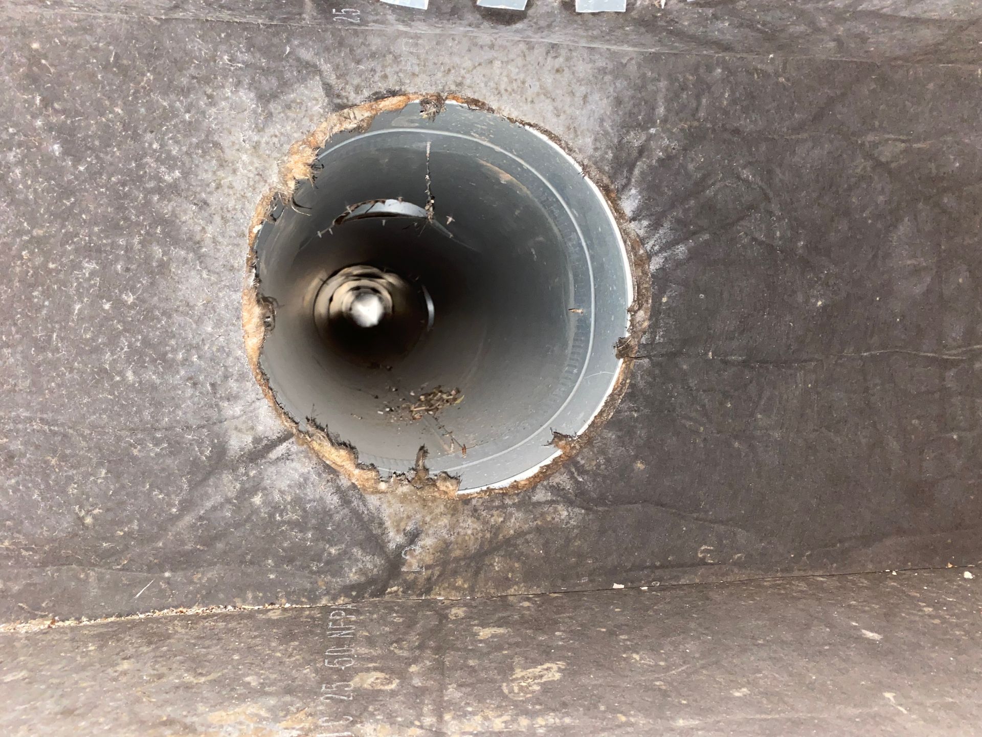 A metal pipe with a hole in the middle of it