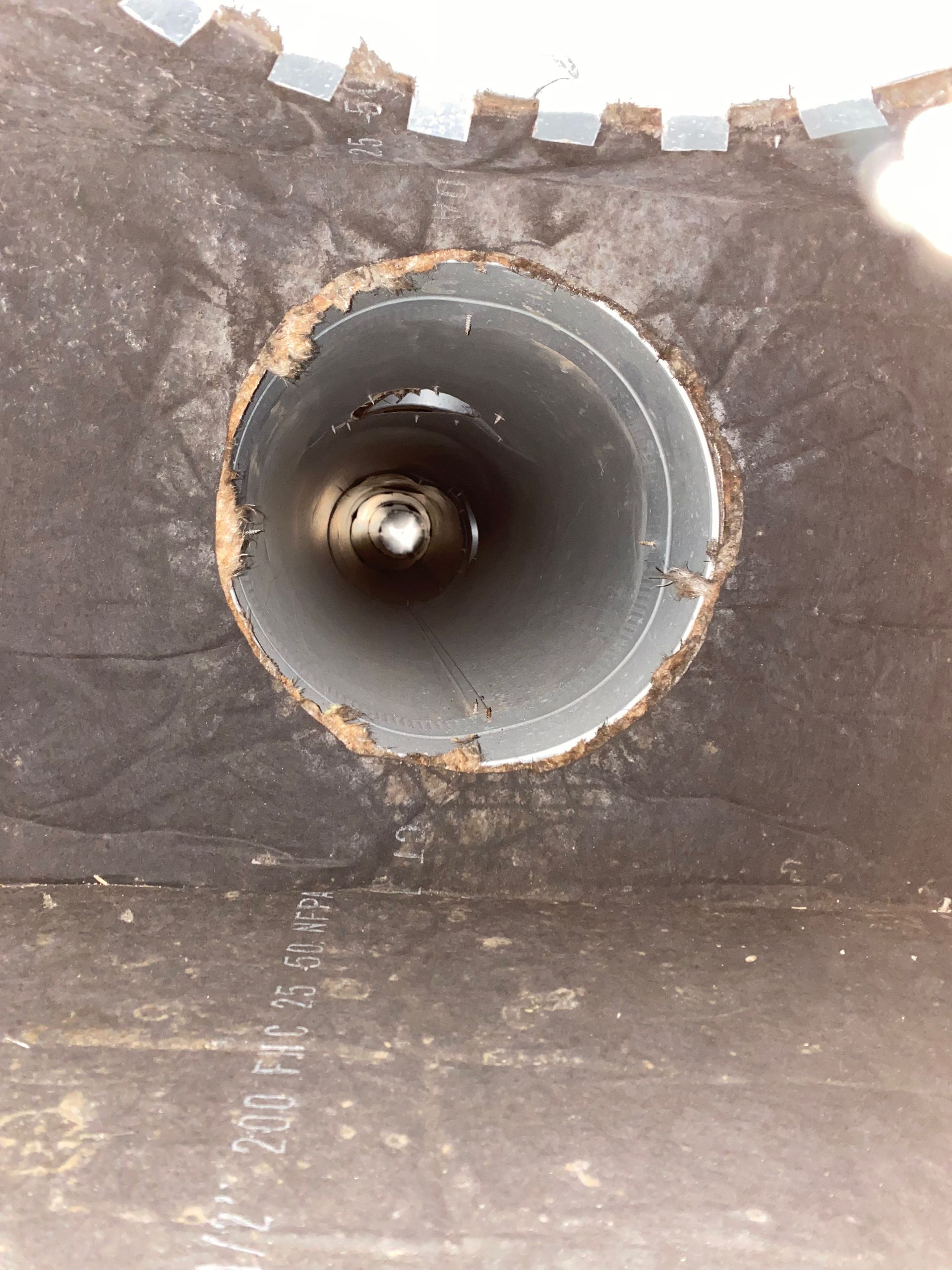 A hole in a wall with a circle in the middle