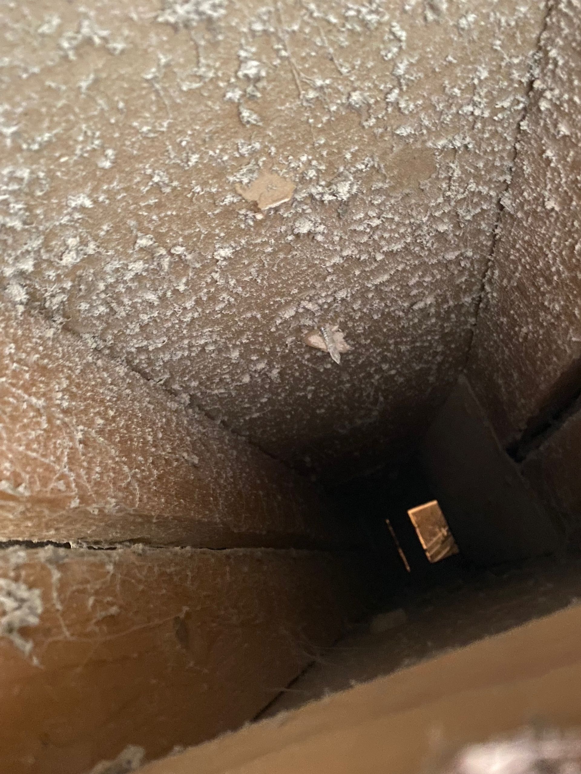 A hole in a wall with a light coming out of it