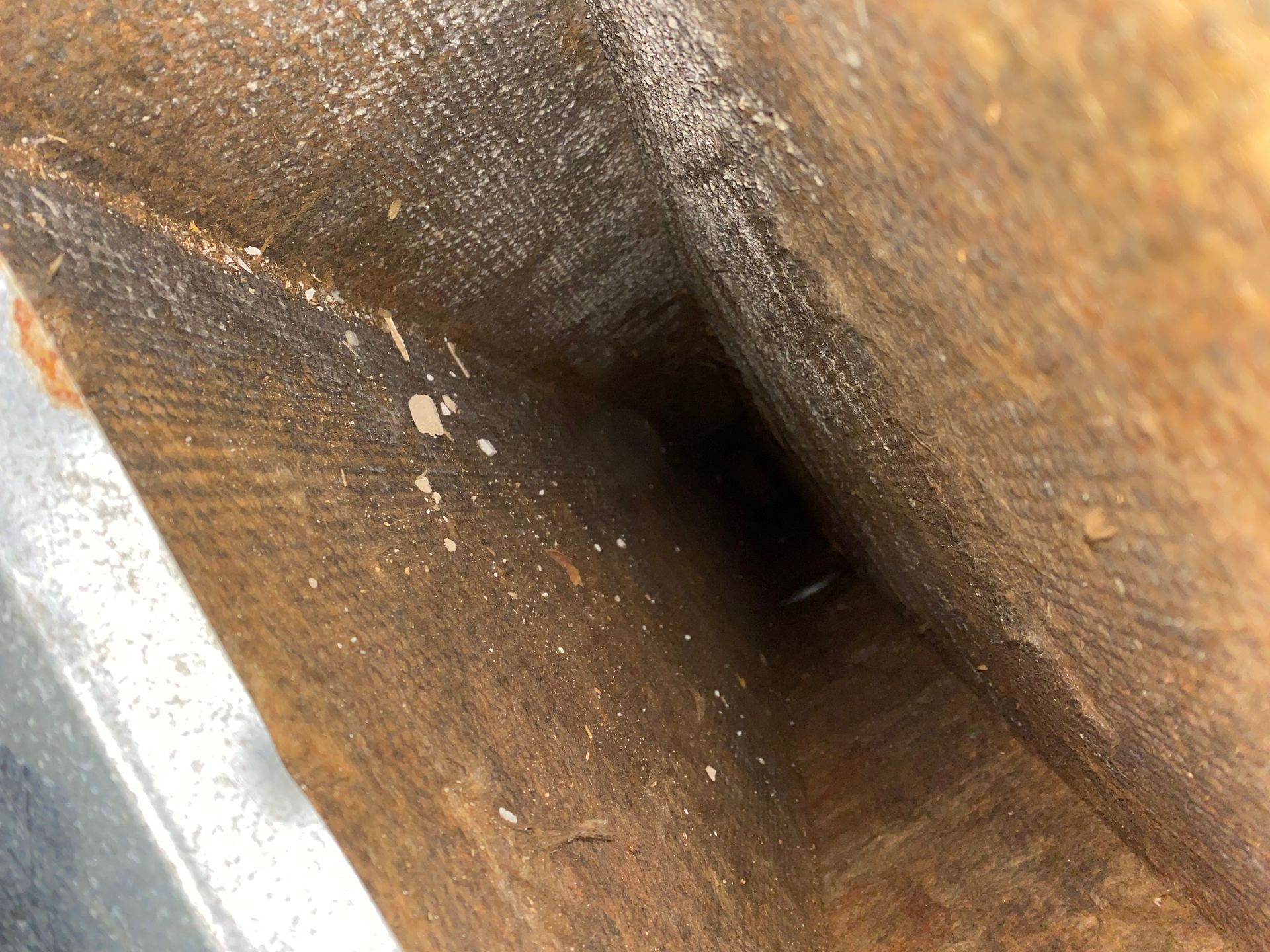 A close up of a piece of wood with a hole in it
