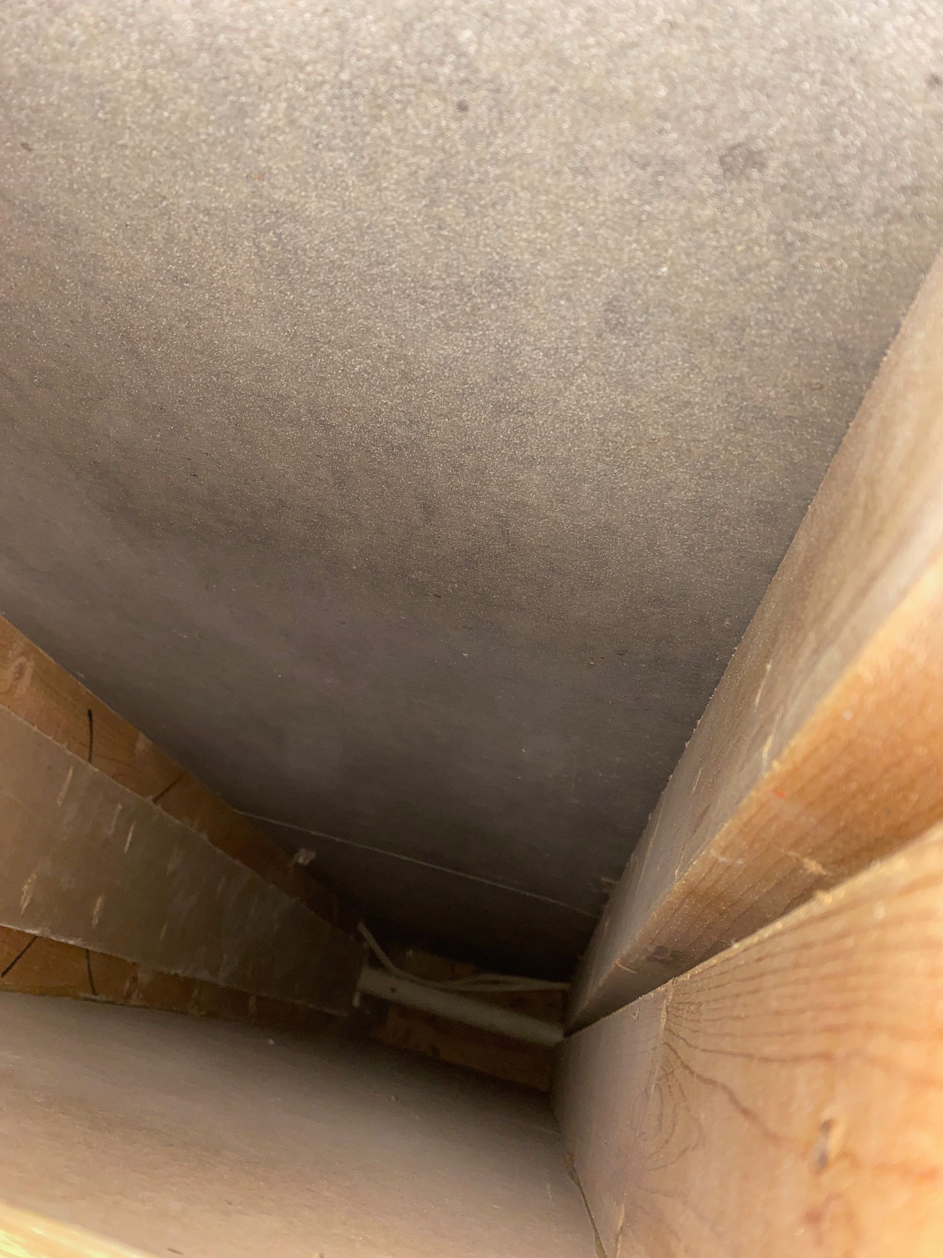Looking up at the ceiling of a room with wooden beams.