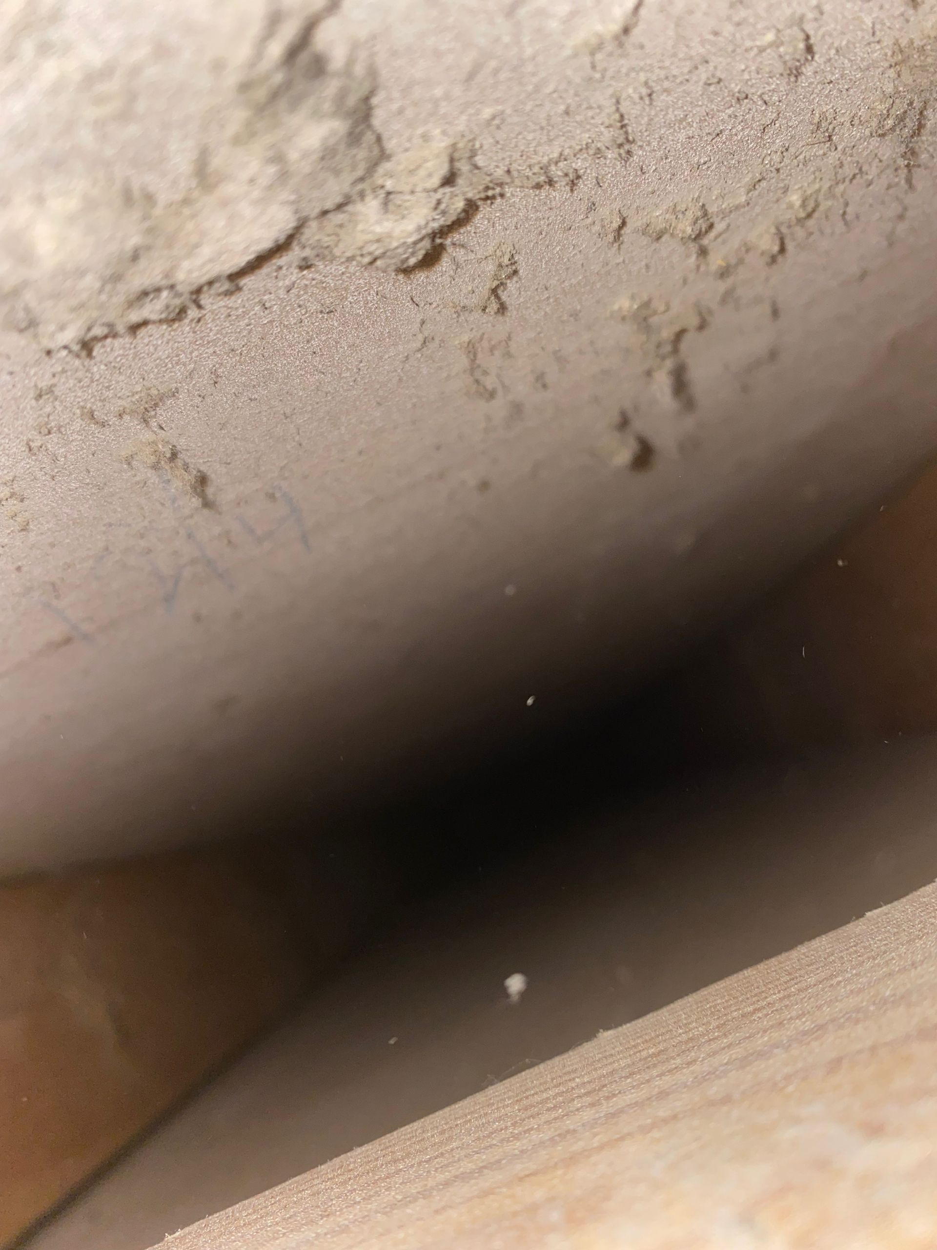 A close up of a ceiling with a hole in it.