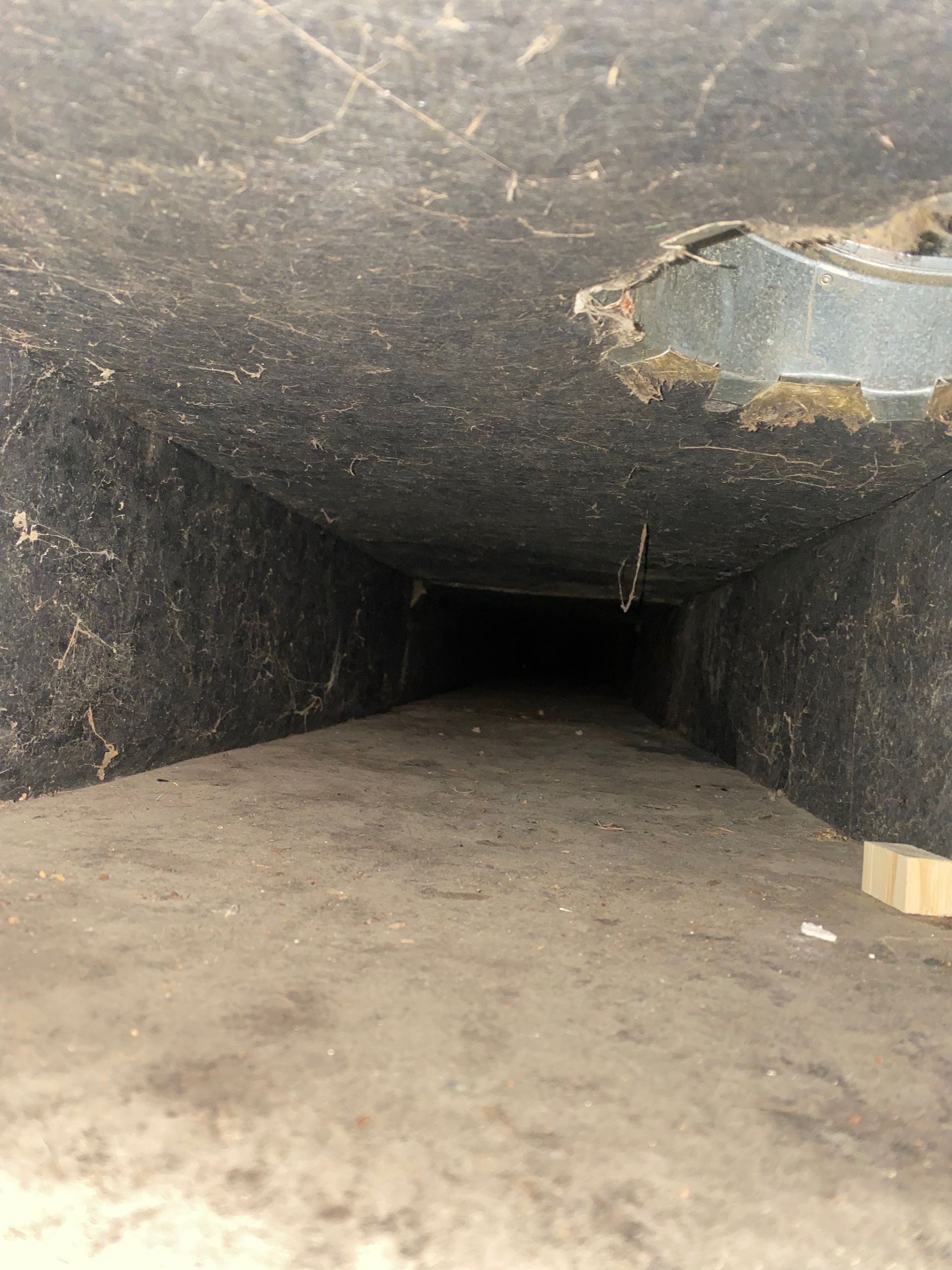 A dark tunnel with a few holes in it