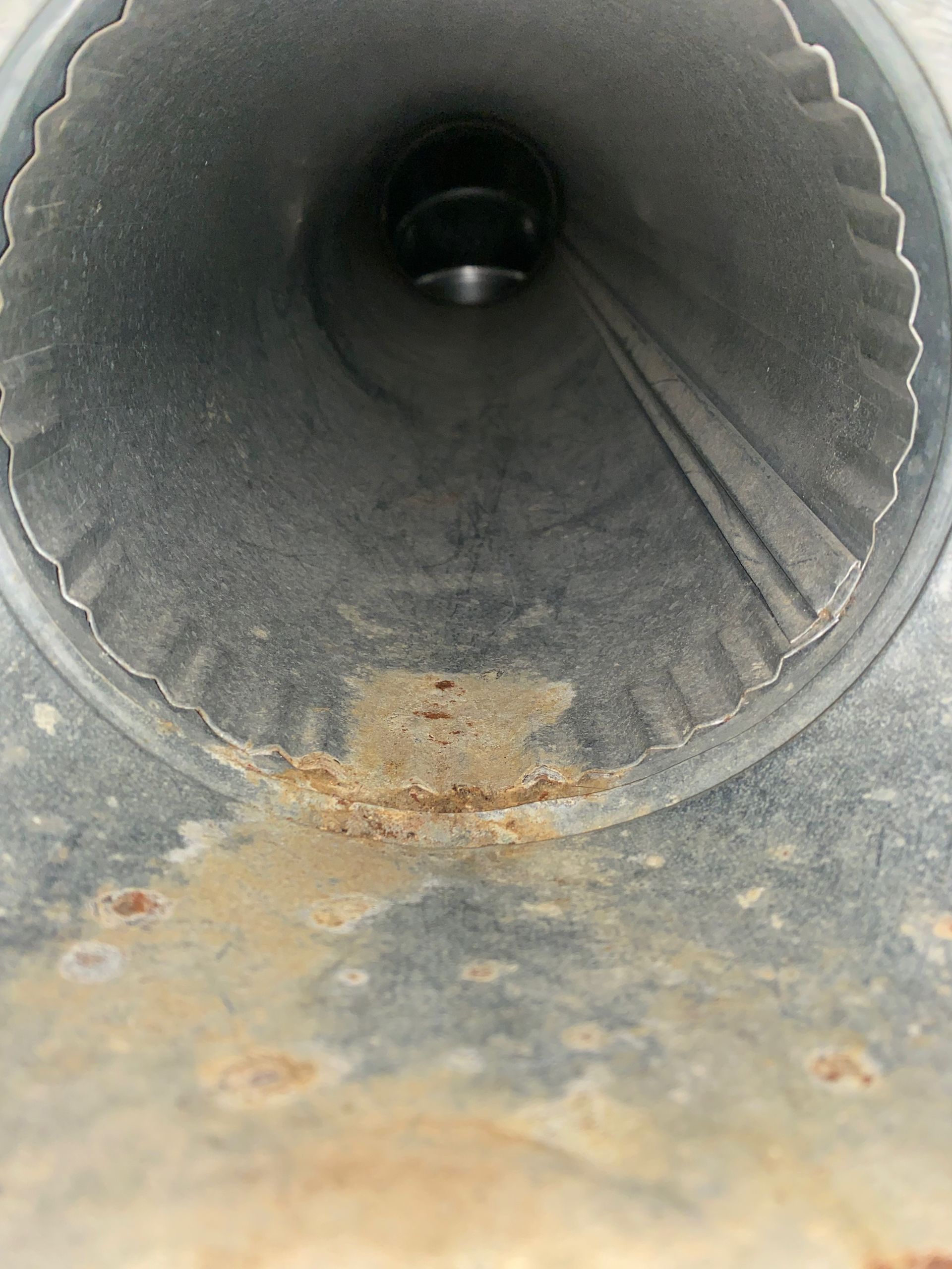 A close up of a metal pipe with rust on it