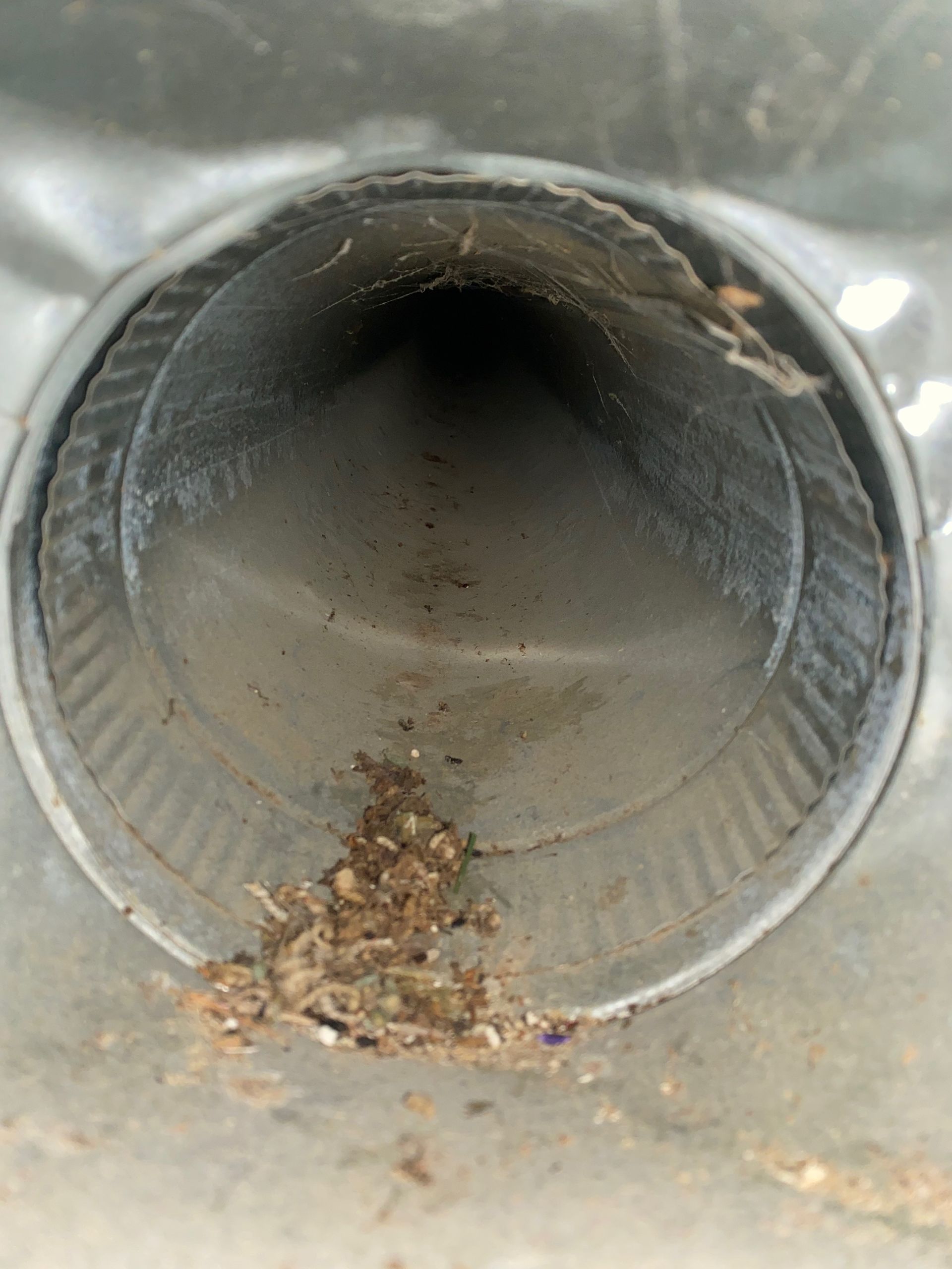 A close up of a metal pipe with a hole in it