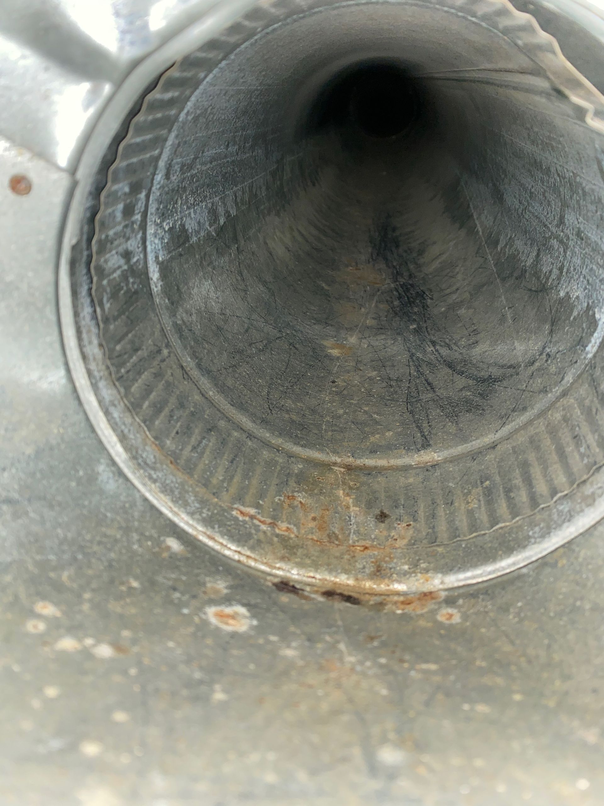 A close up of a metal pipe with a hole in the middle