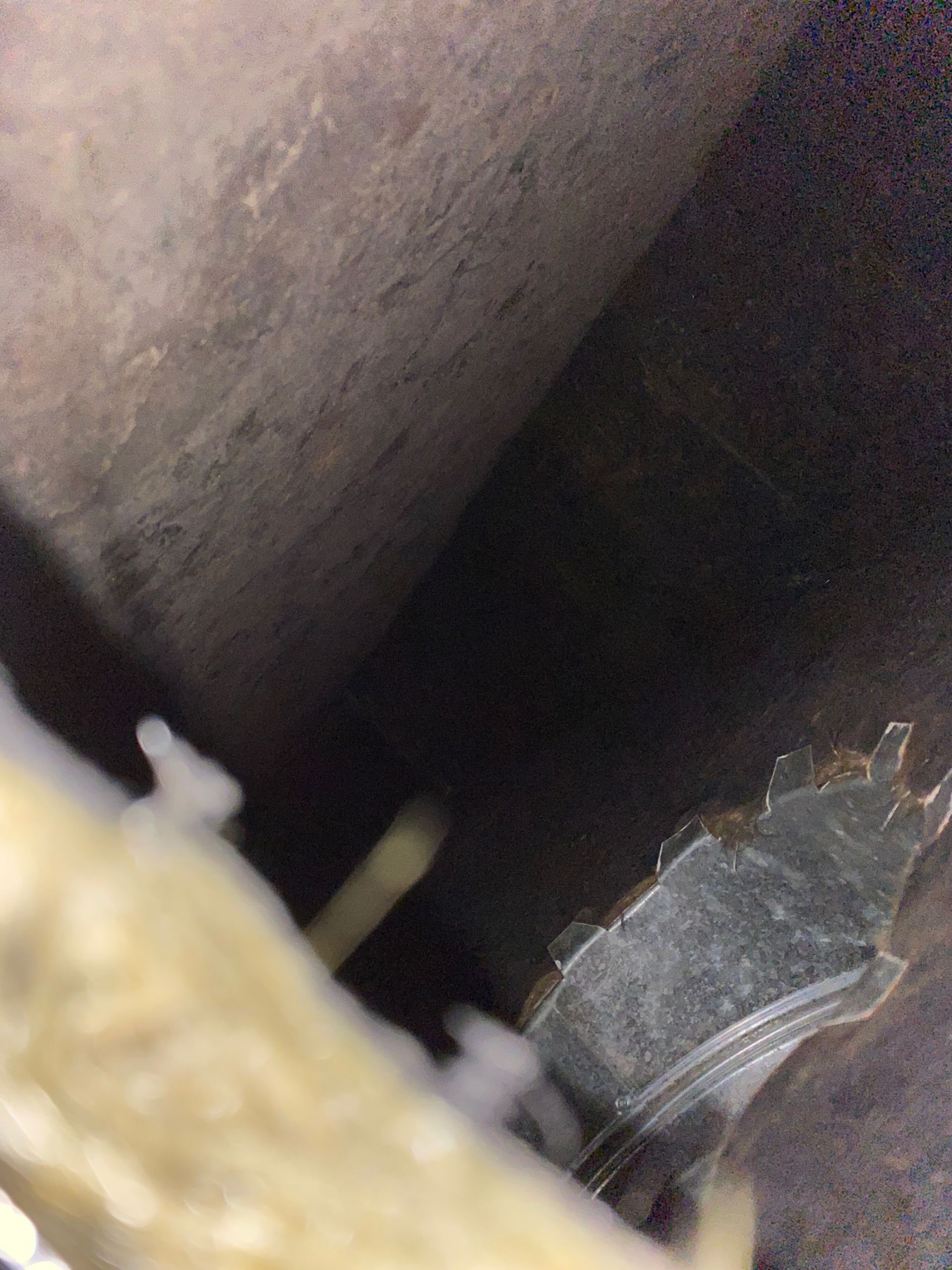 A close up of a metal pipe in a dark room.