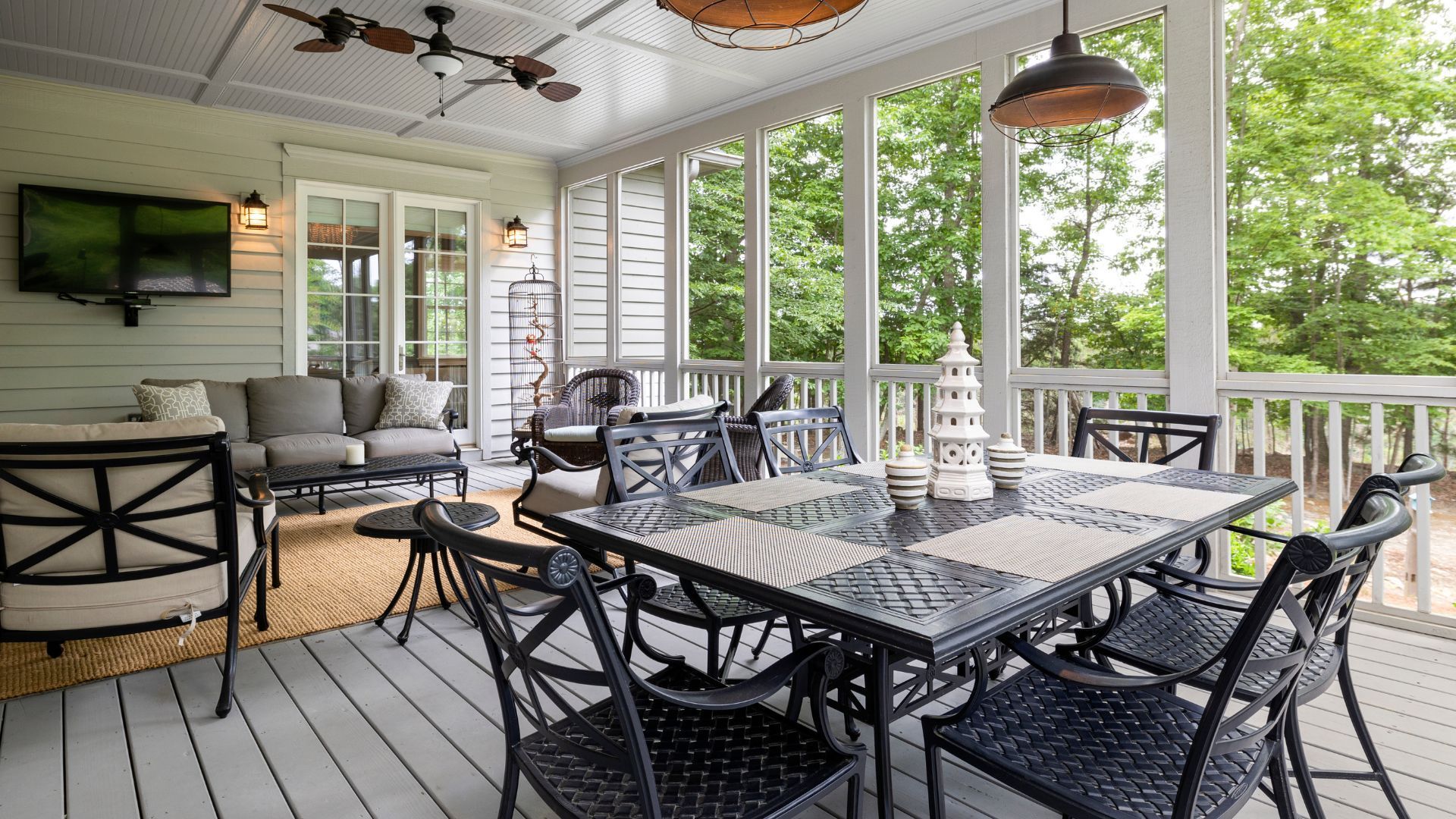 Screened porch in Salinas, CA with outdoor dining set, wicker sofas, TV, and decorative accents.