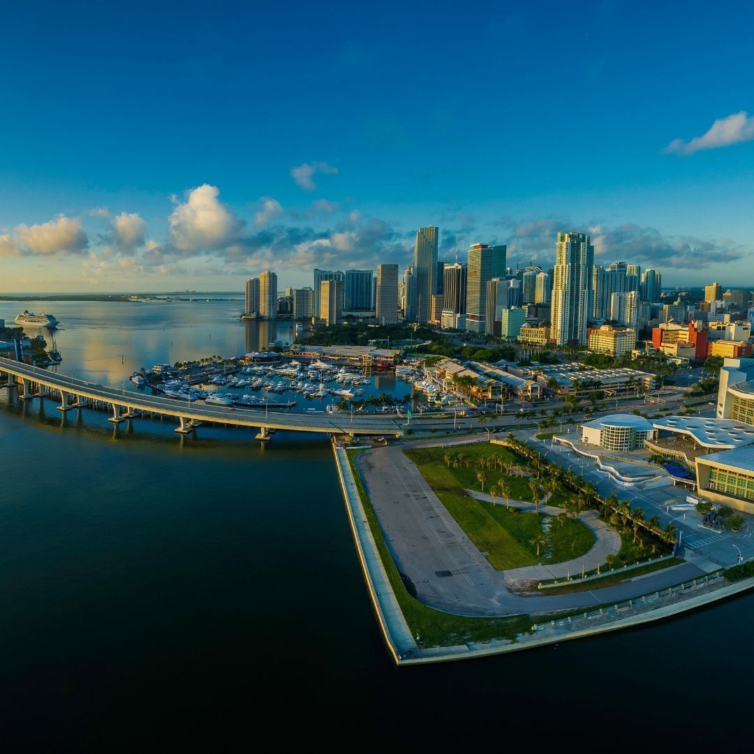 An aerial view of a city with a bridge over a body of water.