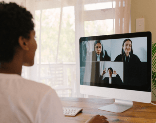 woman participating in remote team meeting from home office