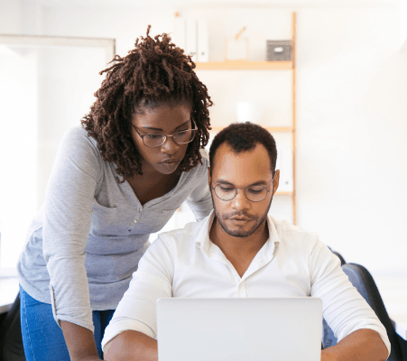 manager and  employee at computer having discussion