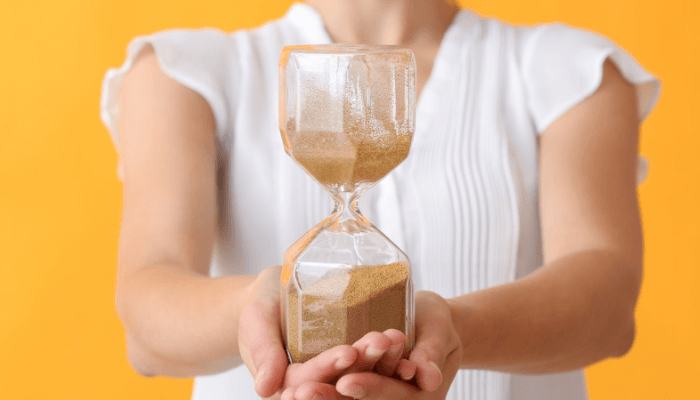 woman holding hourglass