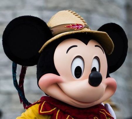 A close up of mickey mouse wearing a hat and scarf