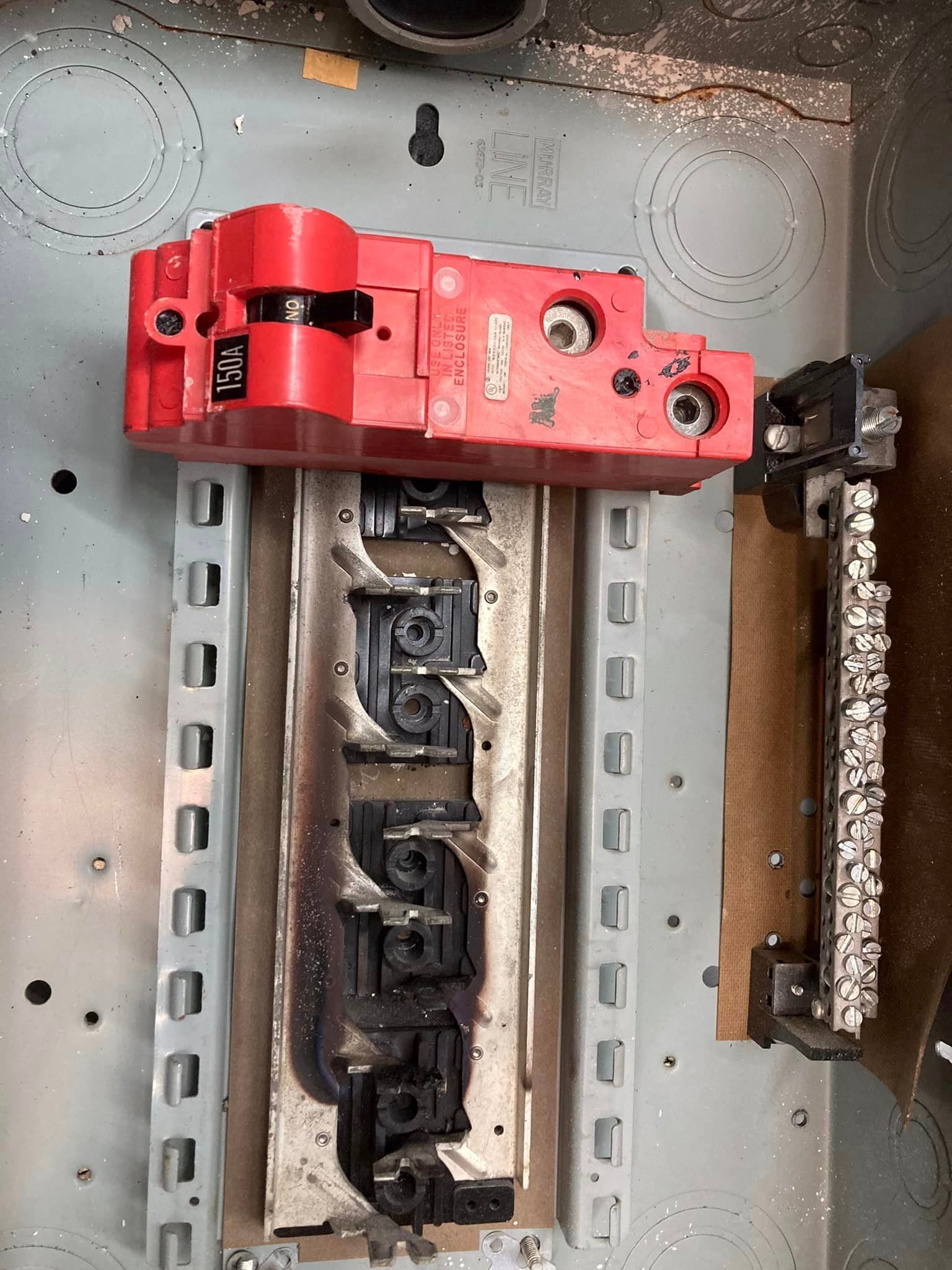 A damaged electrical panel board