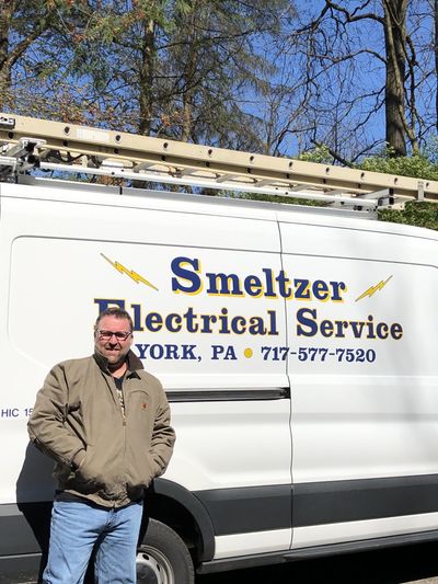 Worker Fixing Ceiling Light — Seven Valleys, PA — Smeltzer Electrical Service, LLC.
