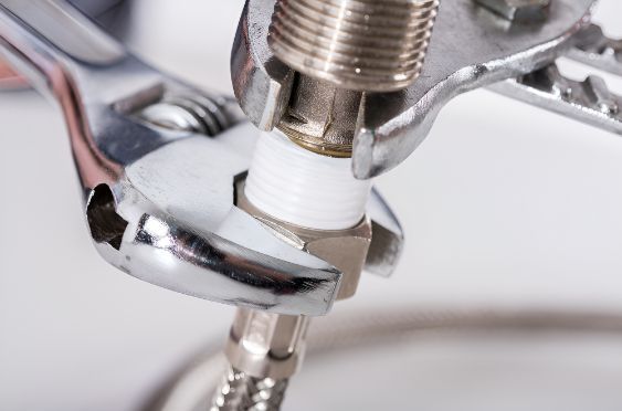 A Wrench Is Being Used To Fix A Faucet — Barney Hinds Plumbing In Point Vernon, QLD