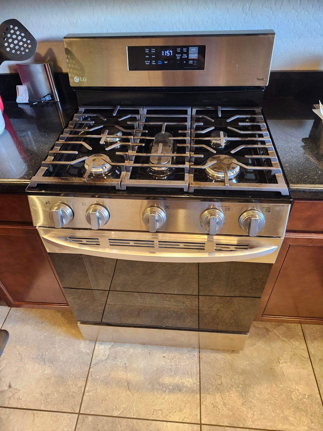 A man is working on a refrigerator with a hose.