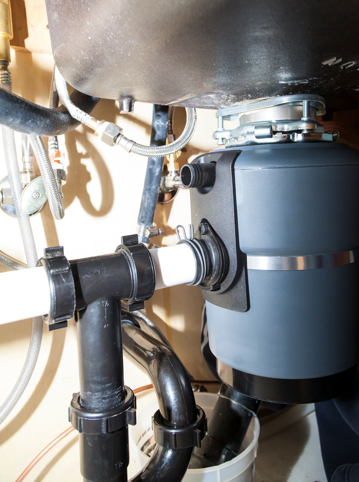 A sink with a garbage disposal attached to it
