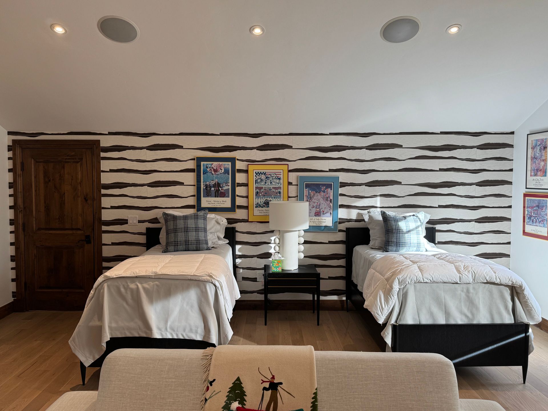 A bedroom with two beds and a couch